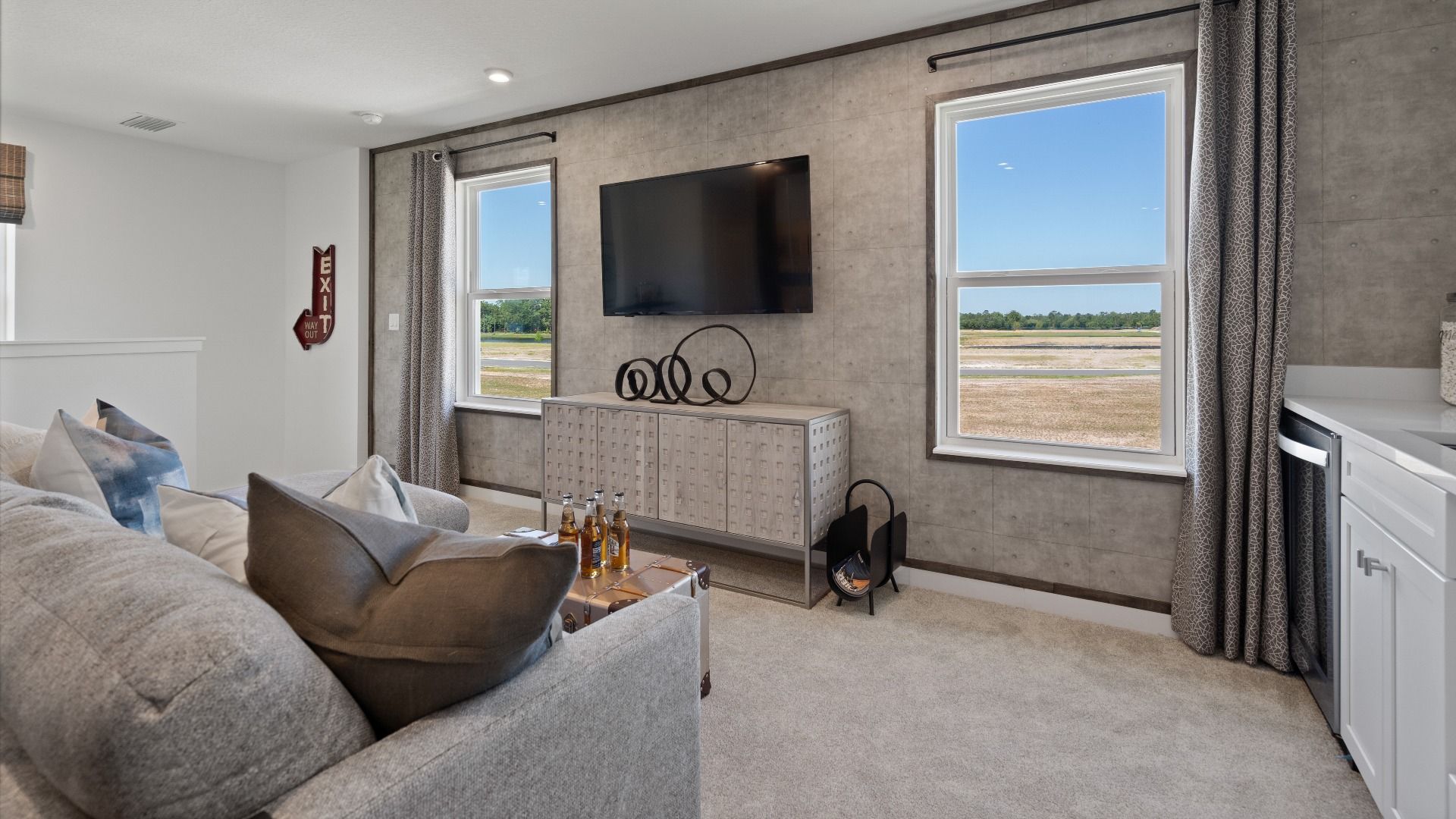 Above garage retreat space with 2 large windows in a DRB Homes Ambersweet model at the Trinity Place community.