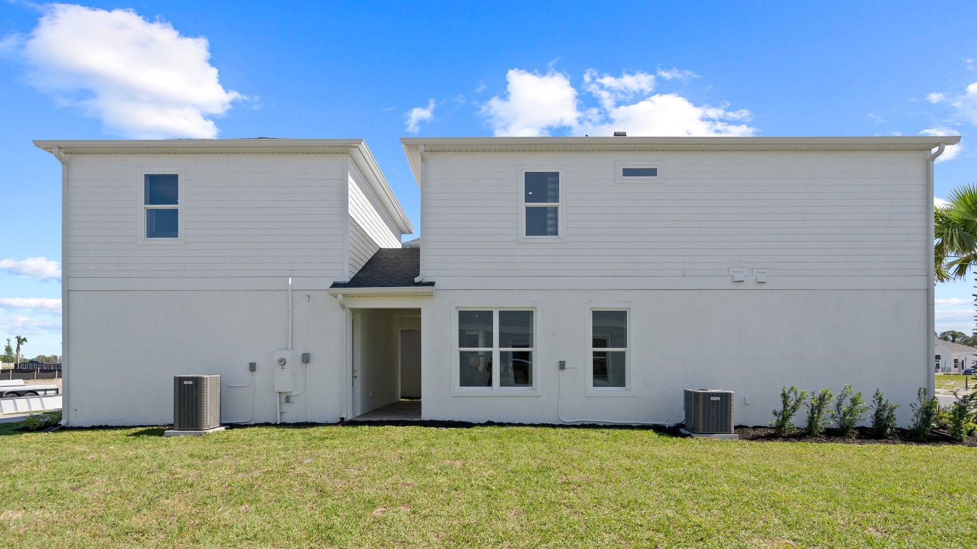 Exterior side view with lanai, 2 car garage and above retreat in a DRB Homes Ambersweet model at the Trinity Place community.