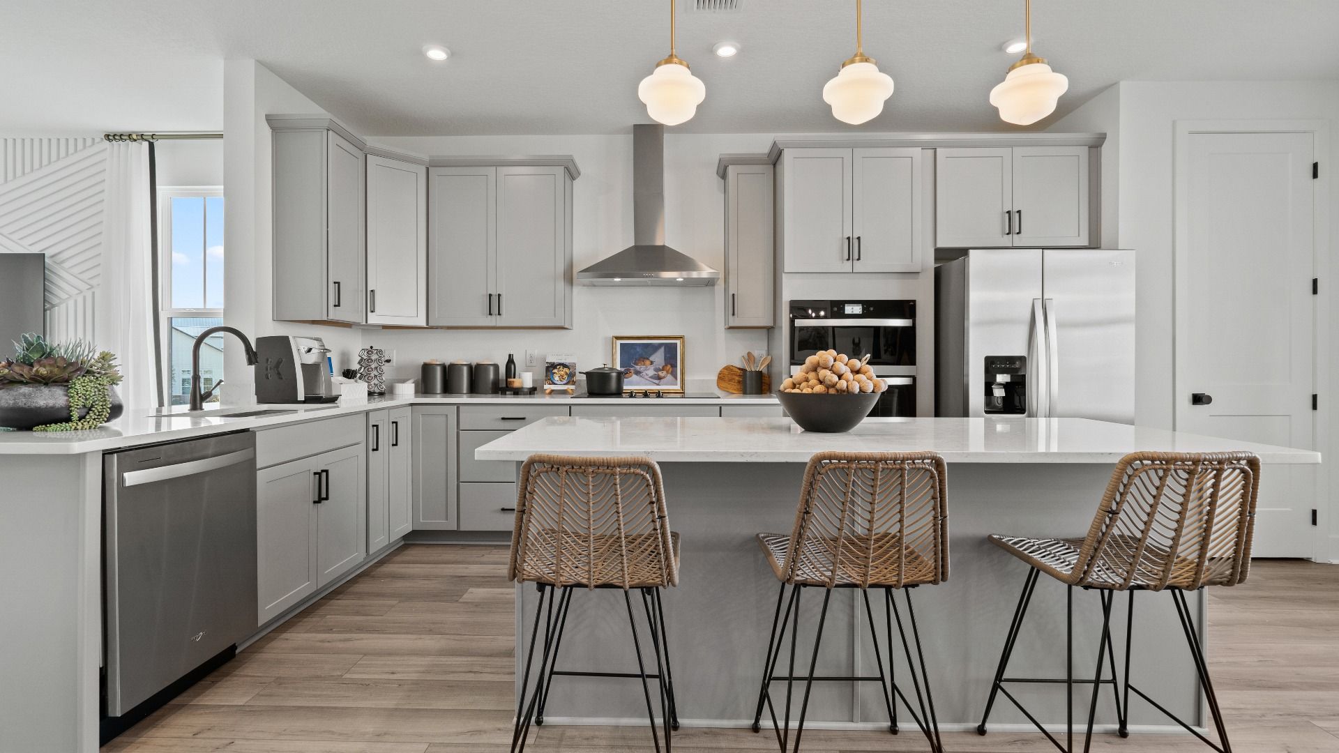 Open-concept gourmet kitchen with sleek gray cabinets and plenty of natural light—style meets function at Parkview at Hamlin
