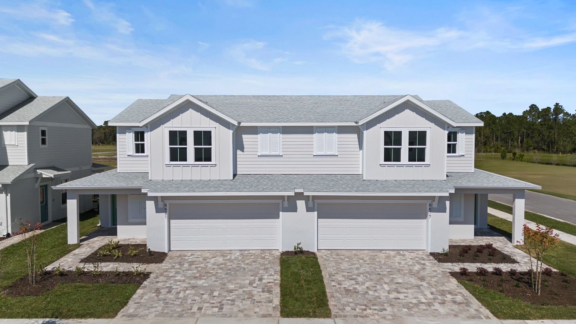 Cyrene at Harmony by DRB Homes offers a two-car garage with a beautiful paver driveway—blending style, space, and convenience