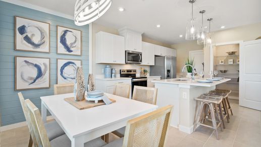 This beautiful open concept coastal kitchen and dining area in the Coronado townhome.