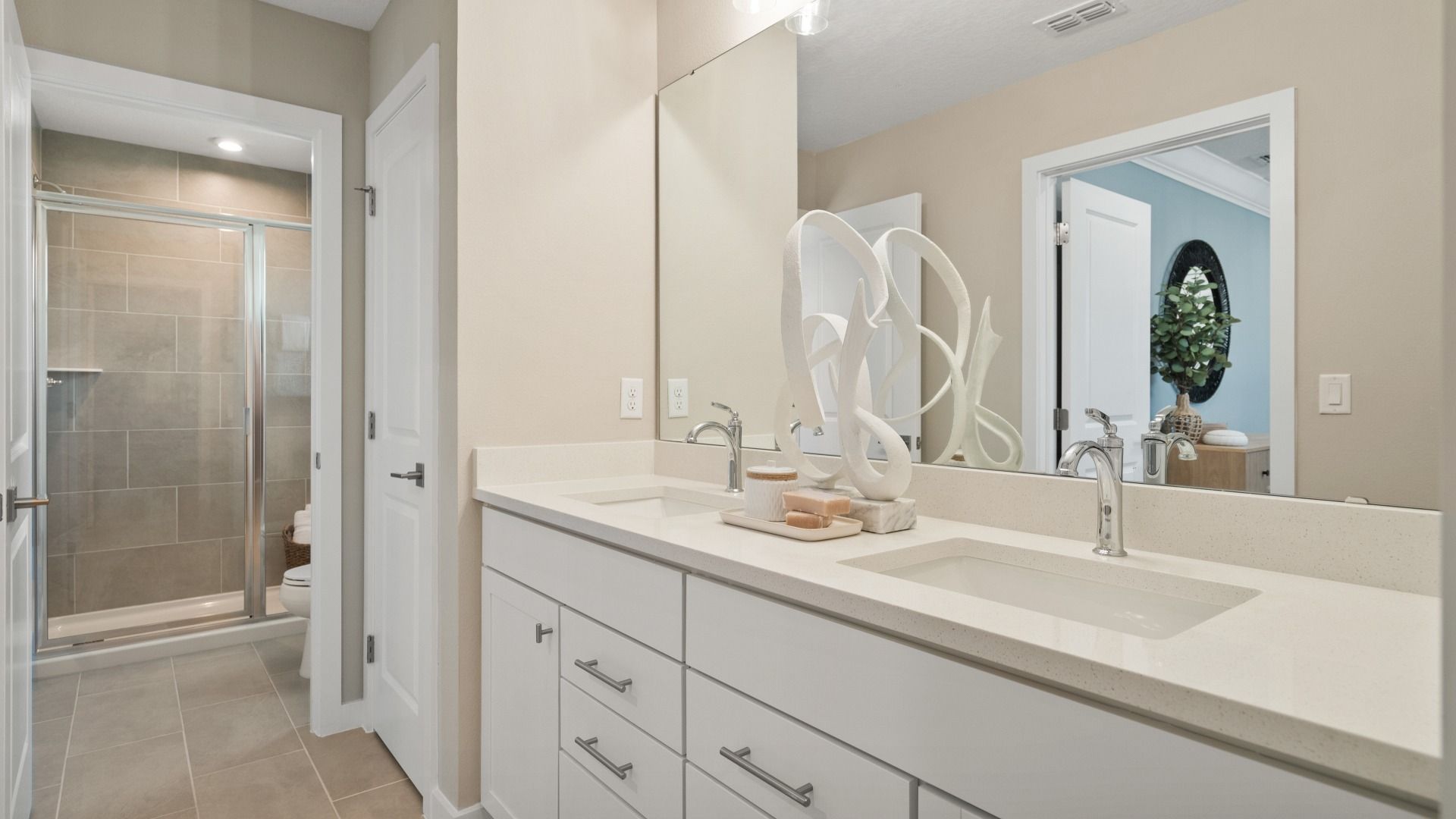 The primary suite at Cyrene at Harmony by DRB Homes features a spacious bathroom with dual sinks