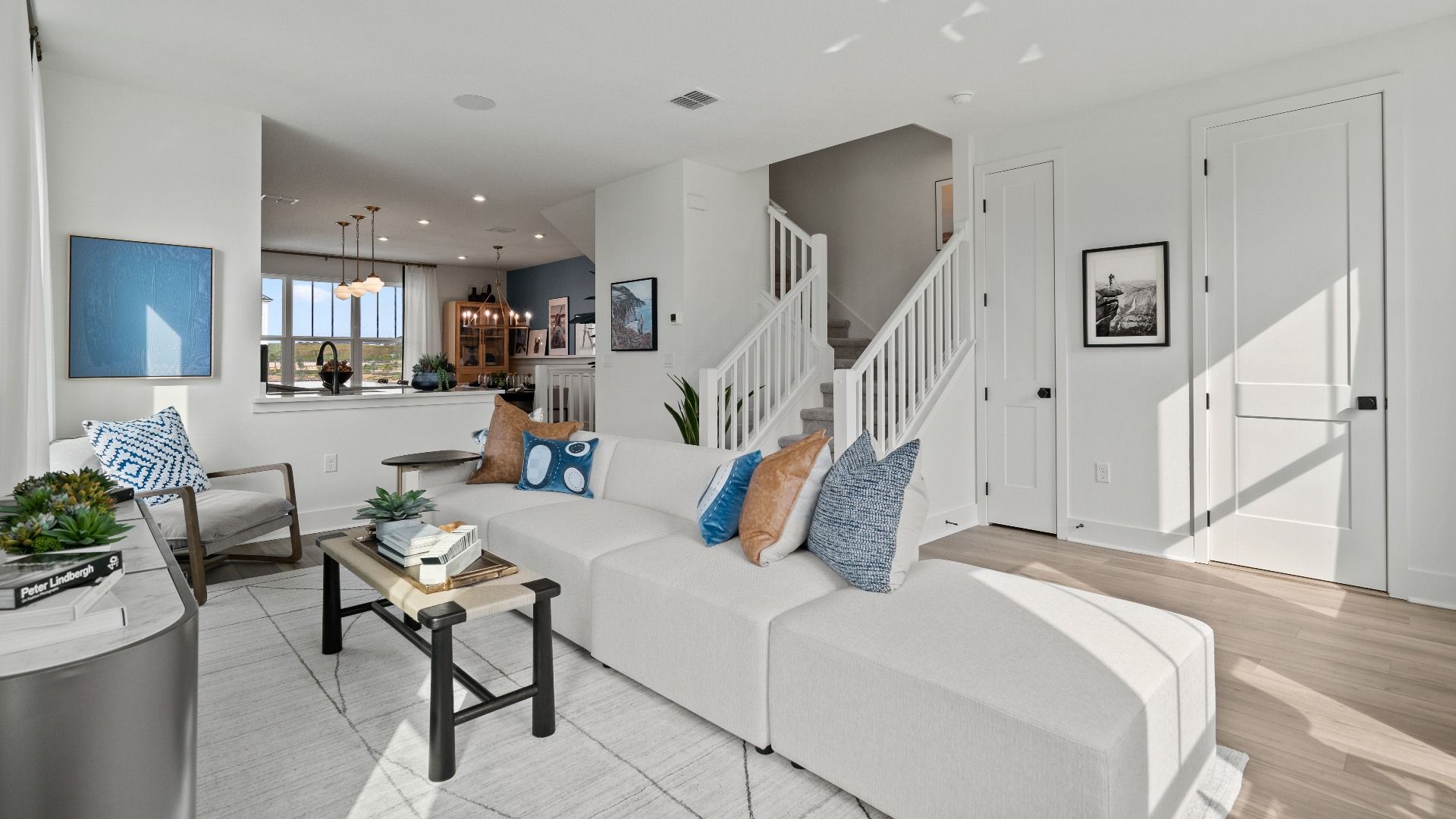 Parkview at Hamlin by DRB Homes offers a connected living room and kitchen space with an open staircase