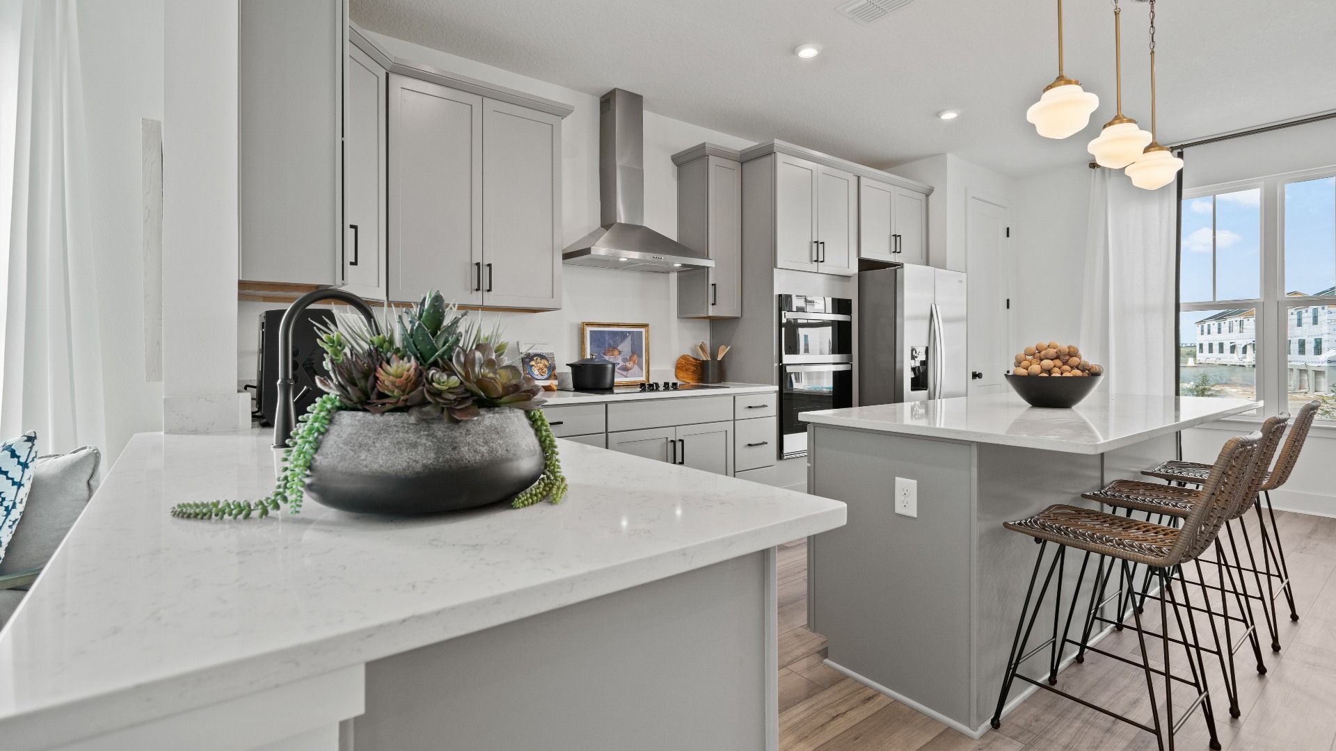 Parkview at Hamlin by DRB Homes features an open kitchen design with large windows that fill the space with natural light