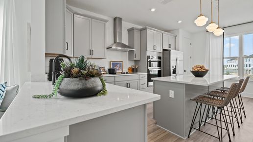 Parkview at Hamlin by DRB Homes features an open kitchen design with large windows that fill the space with natural light