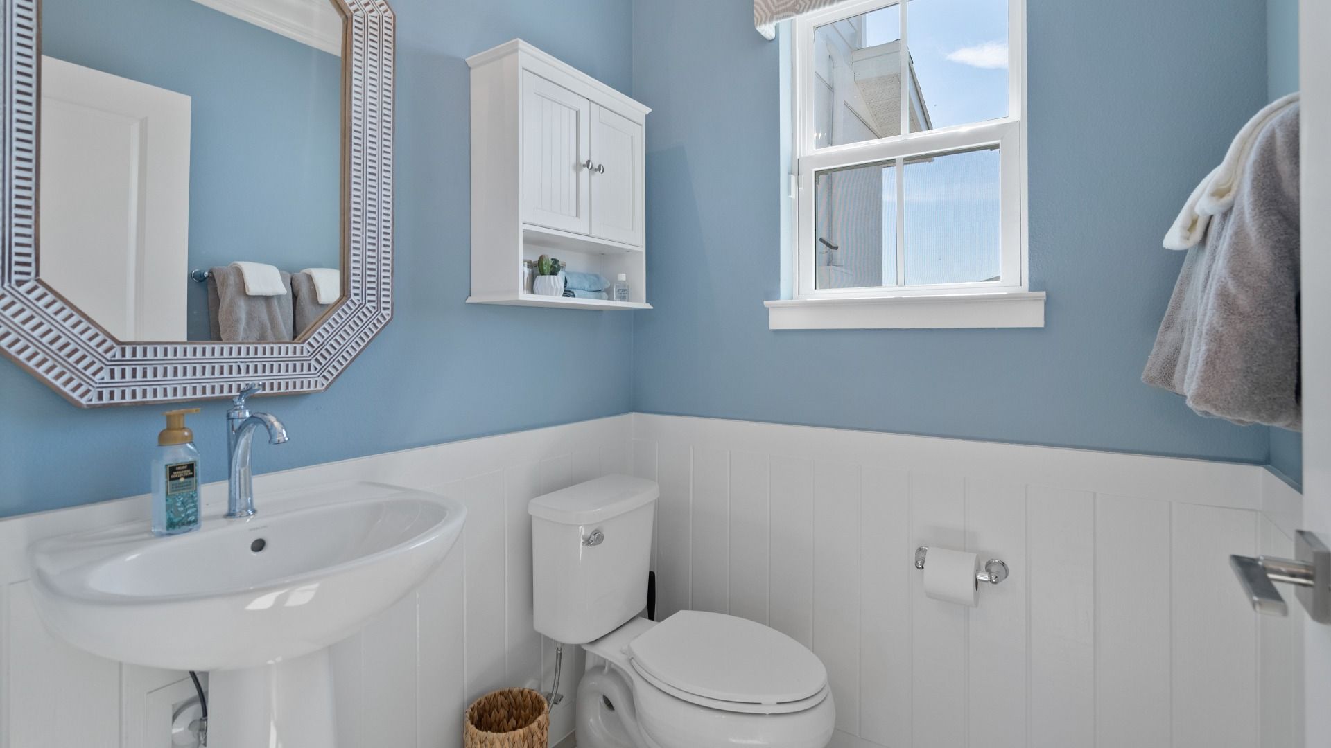 Cyrene at Harmony by DRB Homes includes a downstairs half bathroom with a window—adding natural light and style to the space.