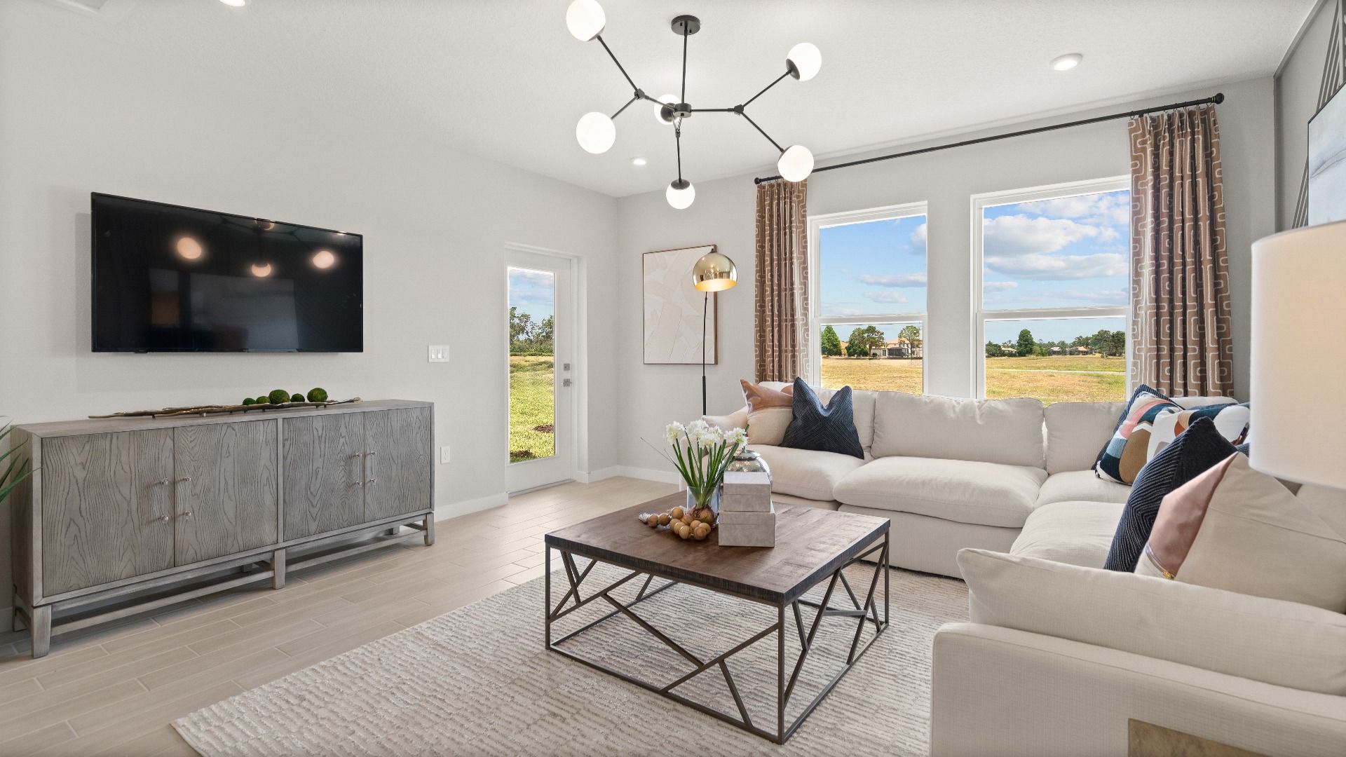 Jupiter Model open concept living room by DRB Homes at Grasslands West, a new construction home in Lakeland FL on golf course