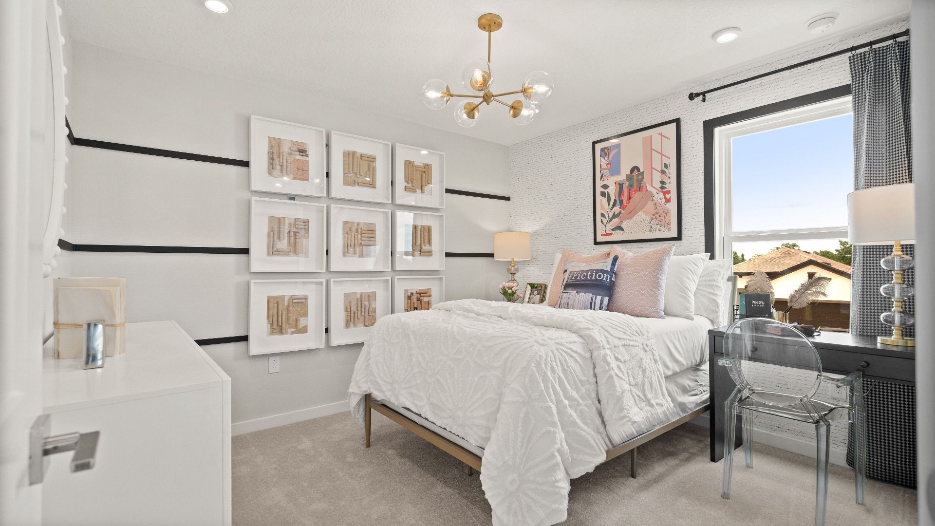 Chic secondary bedroom with custom art wall and workspace in the Jupiter Model at Grasslands West on Grasslands Golf Course.
