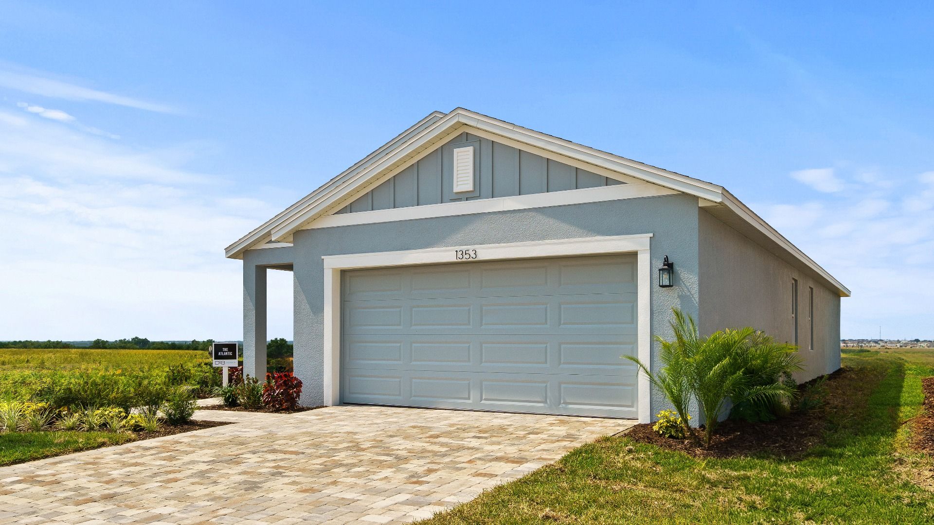 The Atlantic at Hamilton Bluff offers a clean, modern exterior with a 2-car garage, paver driveway, and inviting front entry.