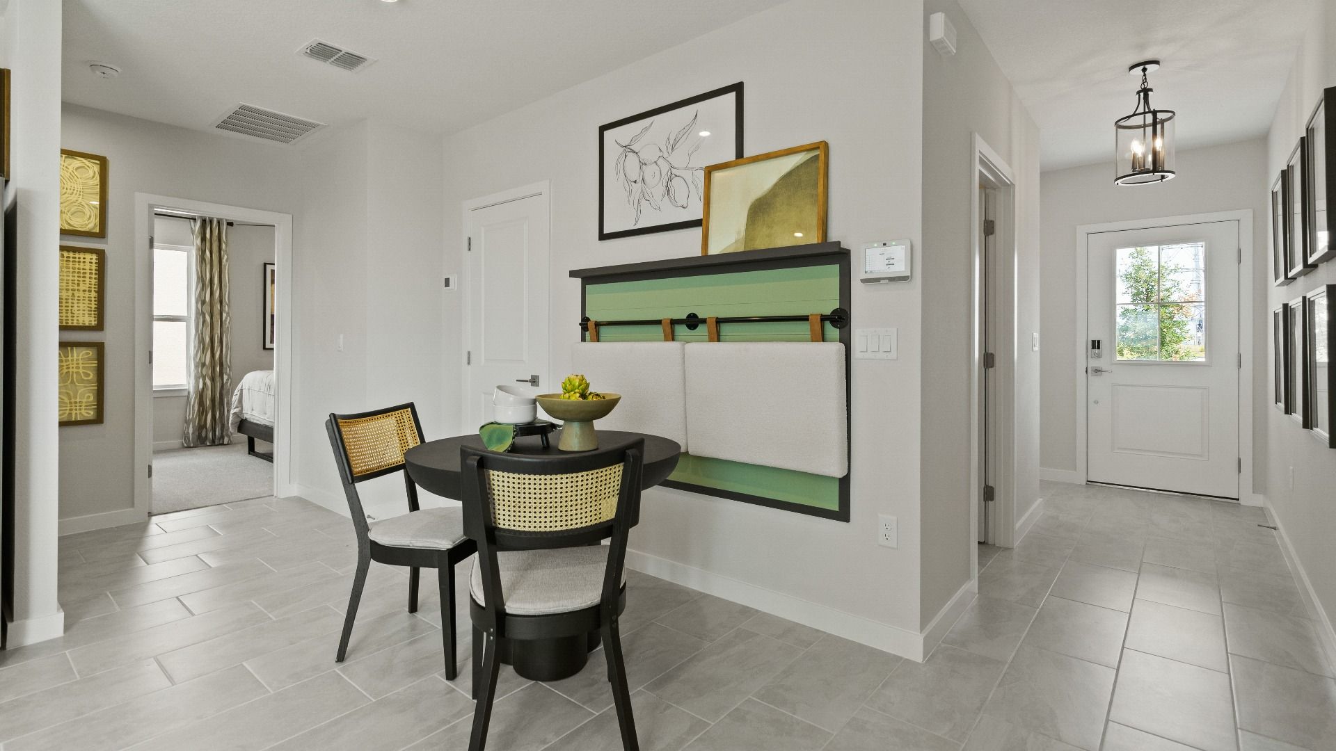 Front flex space with natural light and tile flooring—perfect for dining, entertaining, or a cozy reading nook.