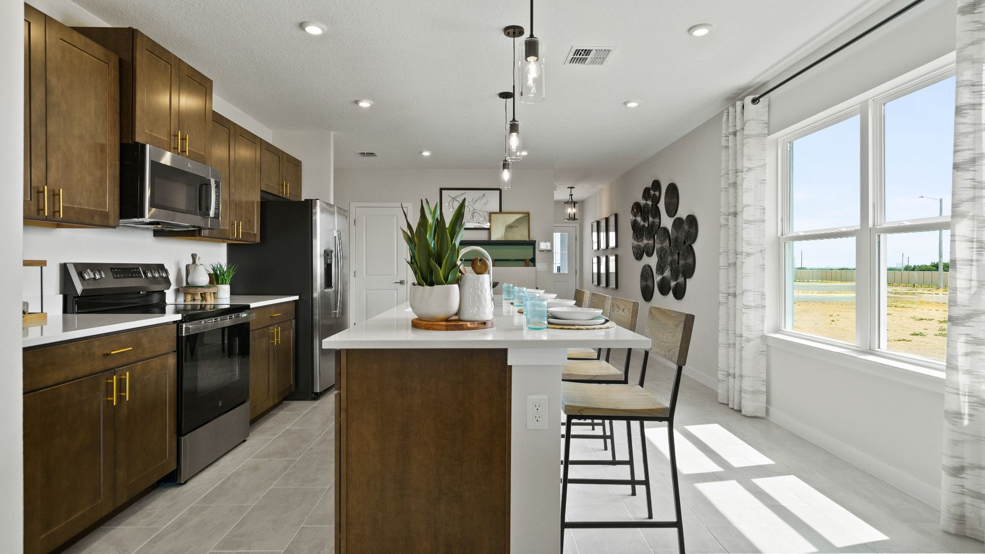 Spacious kitchen with island, stainless steel appliances, and natural light in The Atlantic at Hamilton Bluff.