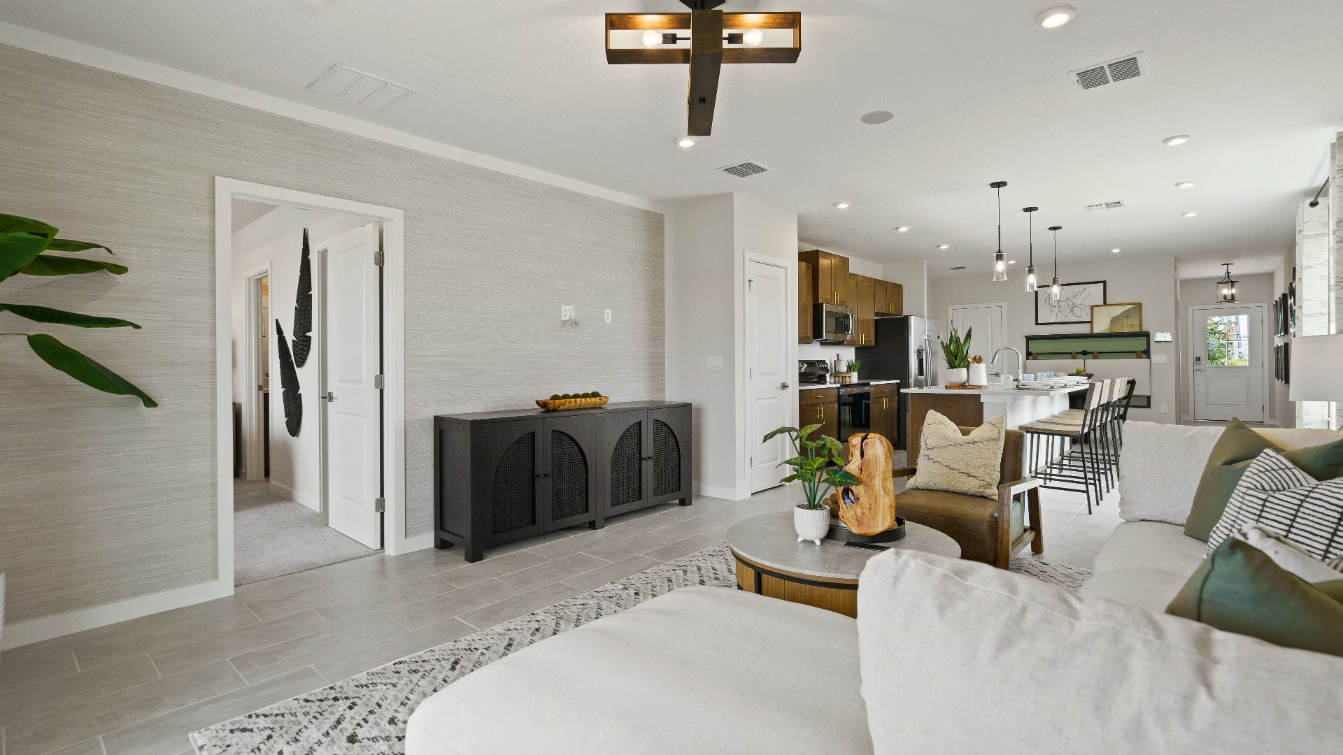 Open-concept layout in The Atlantic with tile flooring, cozy living room, and spacious kitchen for entertaining.