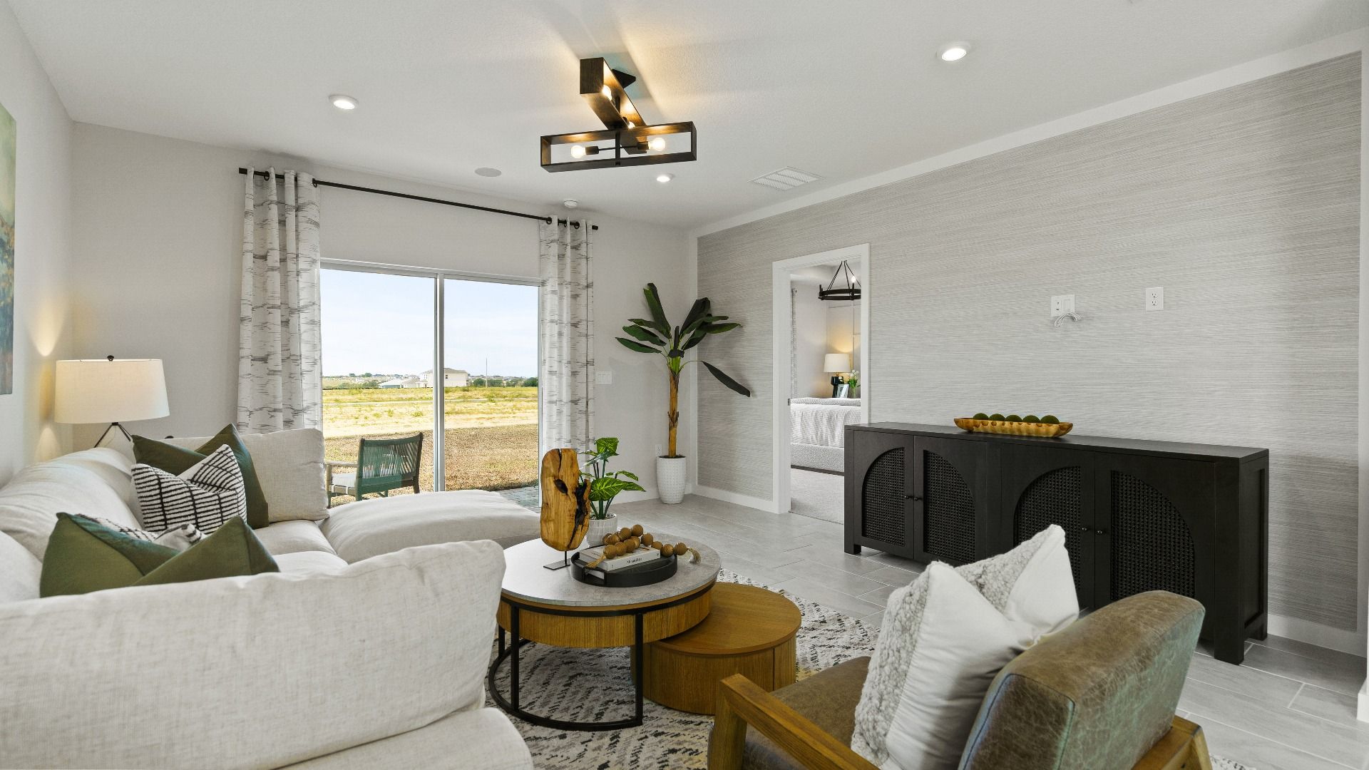 Stylish living room in The Atlantic offers natural light, cozy seating, and easy access to the patio for indoor-outdoor flow.