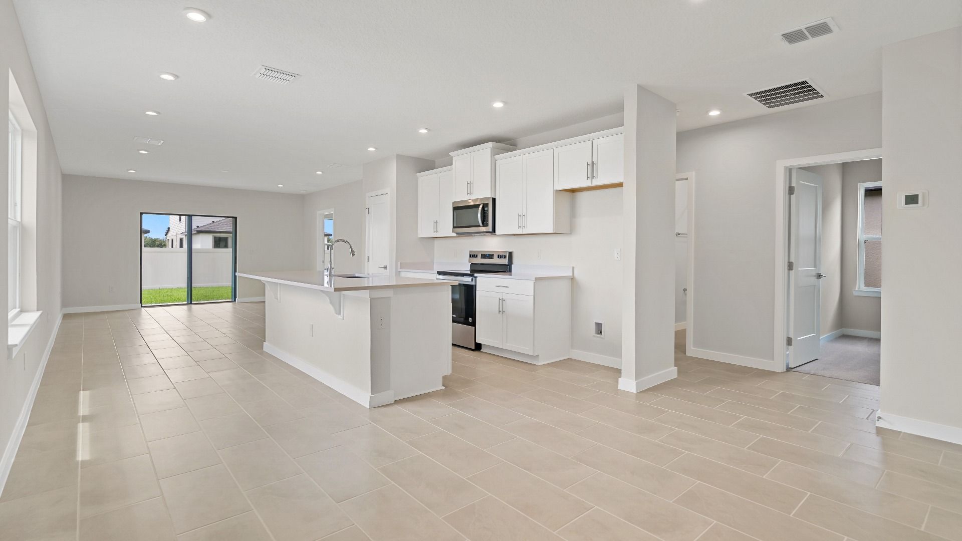 The Atlantic offers a bright open layout with a modern kitchen, island, and connected living space—ideal for everyday living.