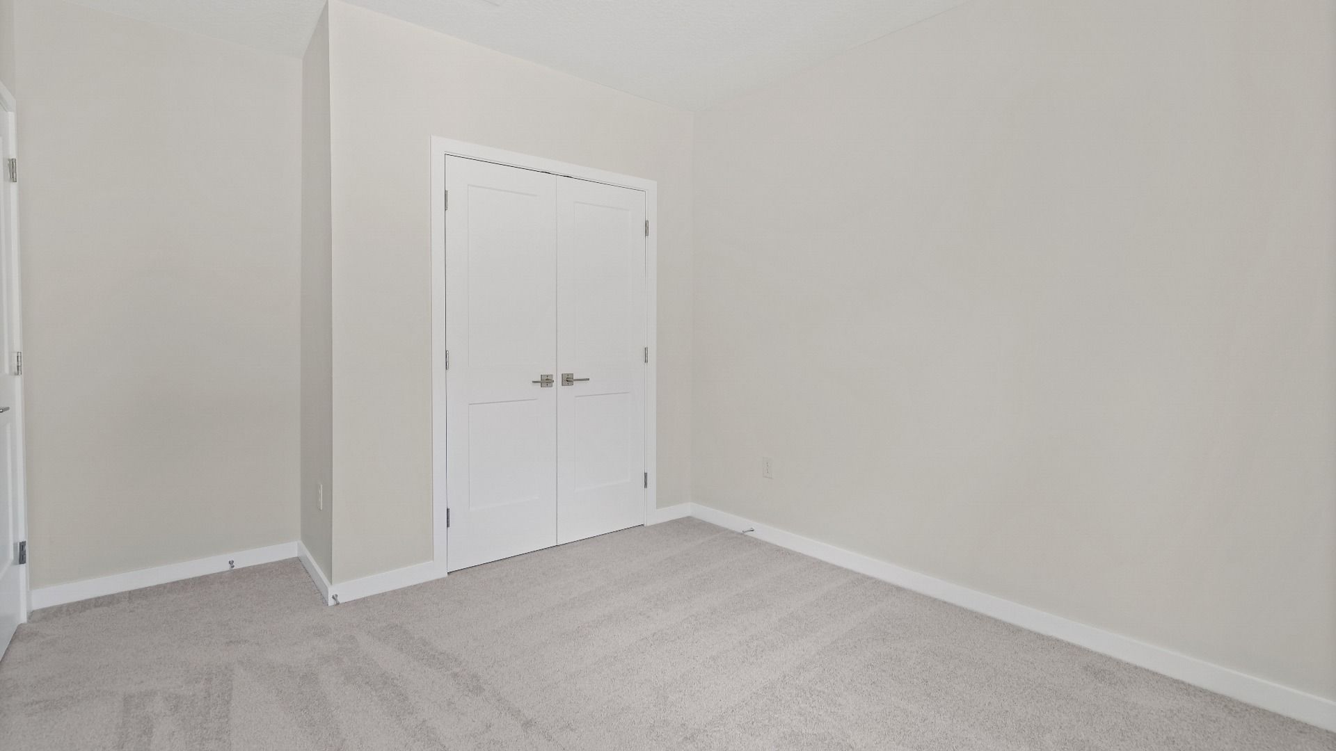 This flex room in The Atlantic works great as a guest bedroom, office, or hobby space with a closet and carpeted flooring.