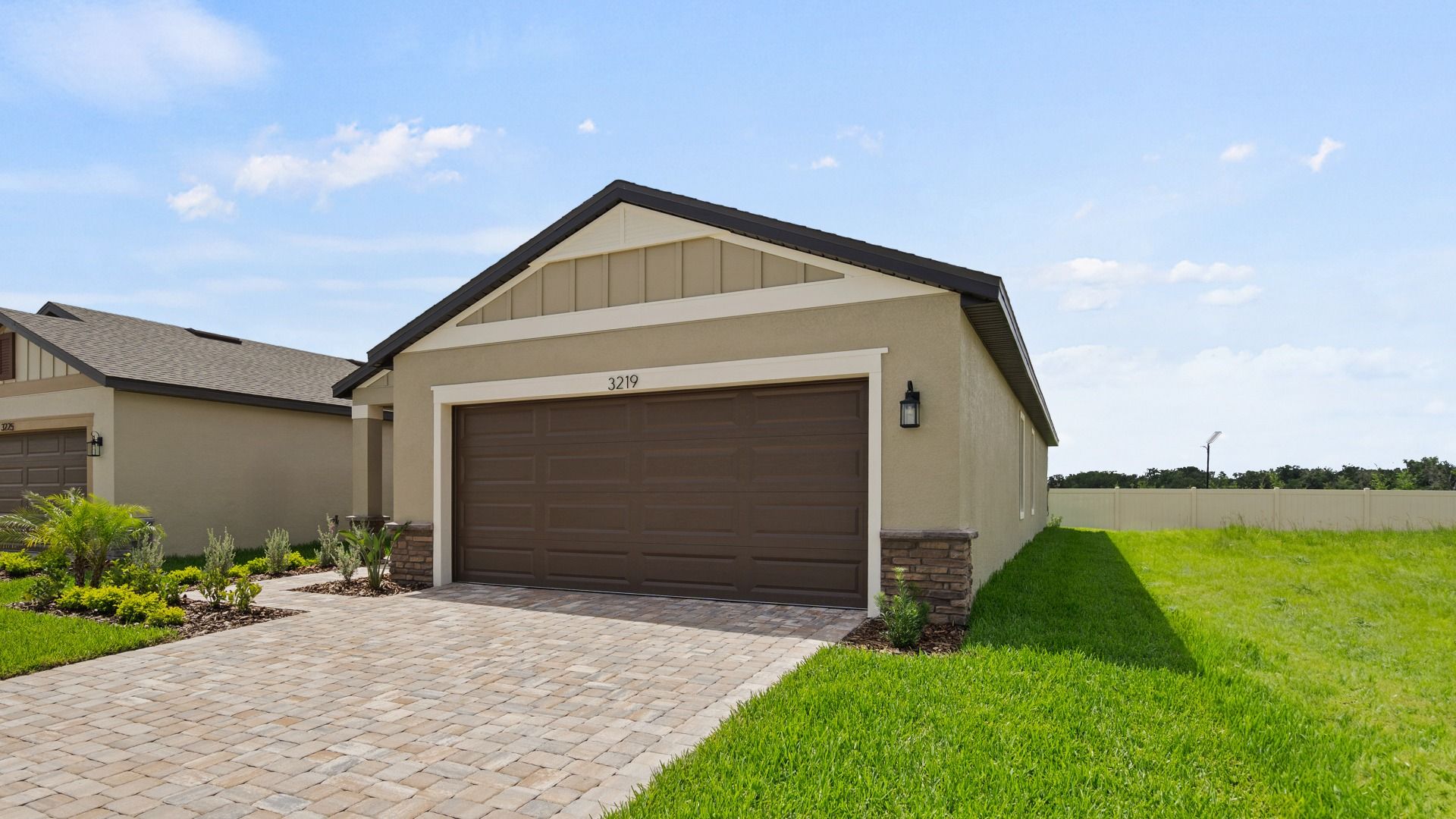 The Flagler at Grasslands West in Lakeland, FL—next to Grasslands Golf Course—features a paver drive and 2-car garage.