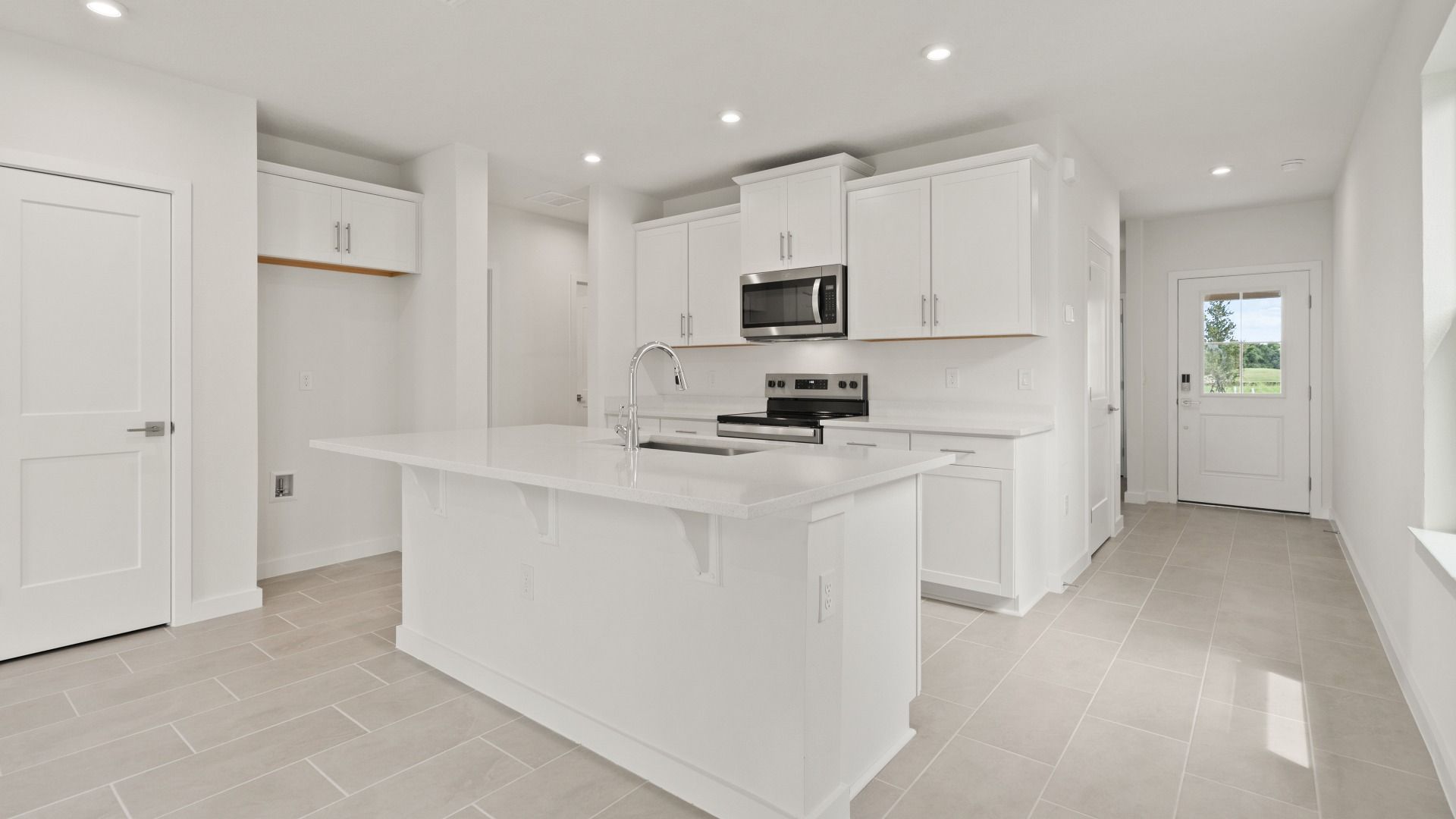The Flagler Floorplan at Grasslands West new home in Lakeland, FL Showcasing a bright Kitchen & Entryway.