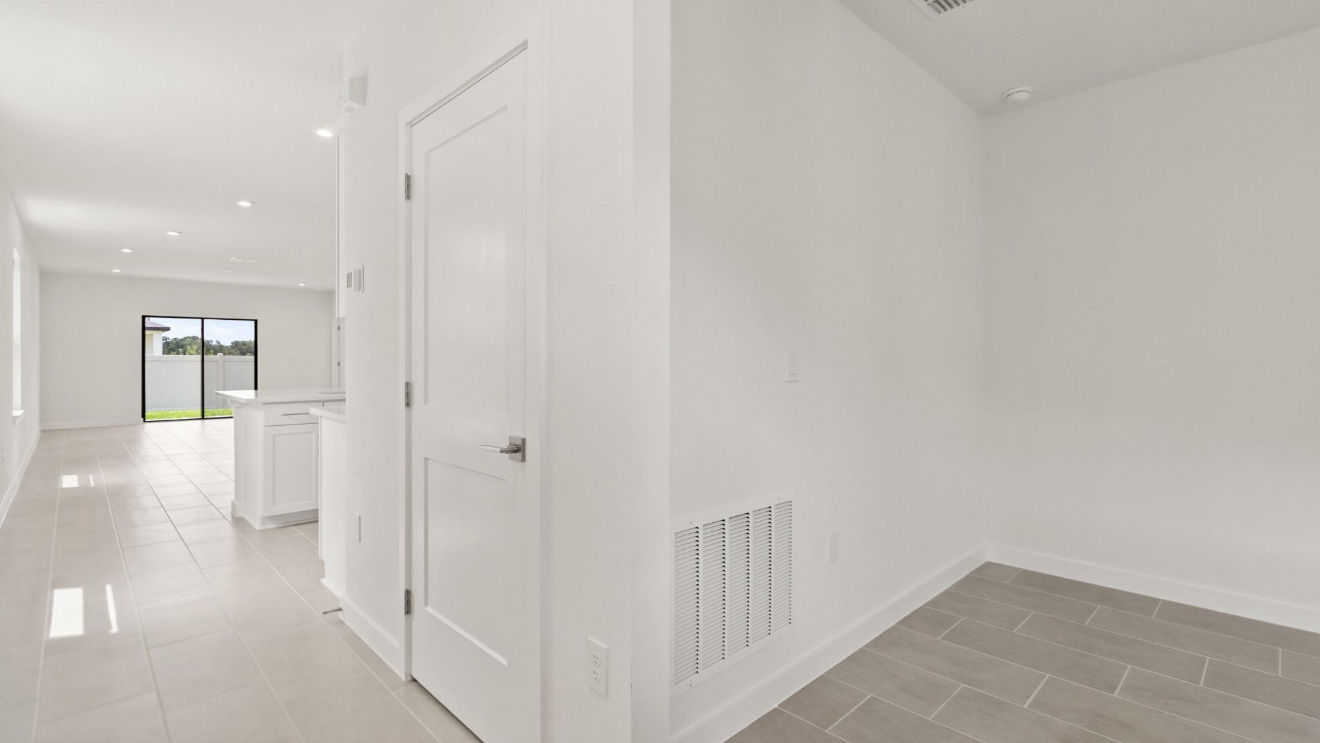 The Flagler Floorplan at Grasslands West new home in Lakeland, FL Showcasing a bright Kitchen & Entryway.