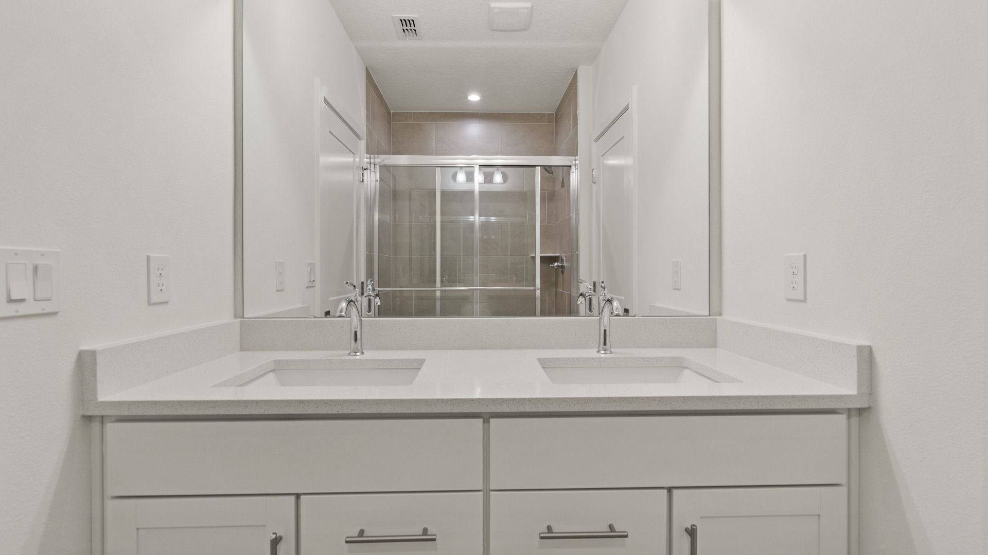 The Flagler Floorplan at Grasslands West new home in Lakeland, FL Showcasing a dual sink primary bathroom.