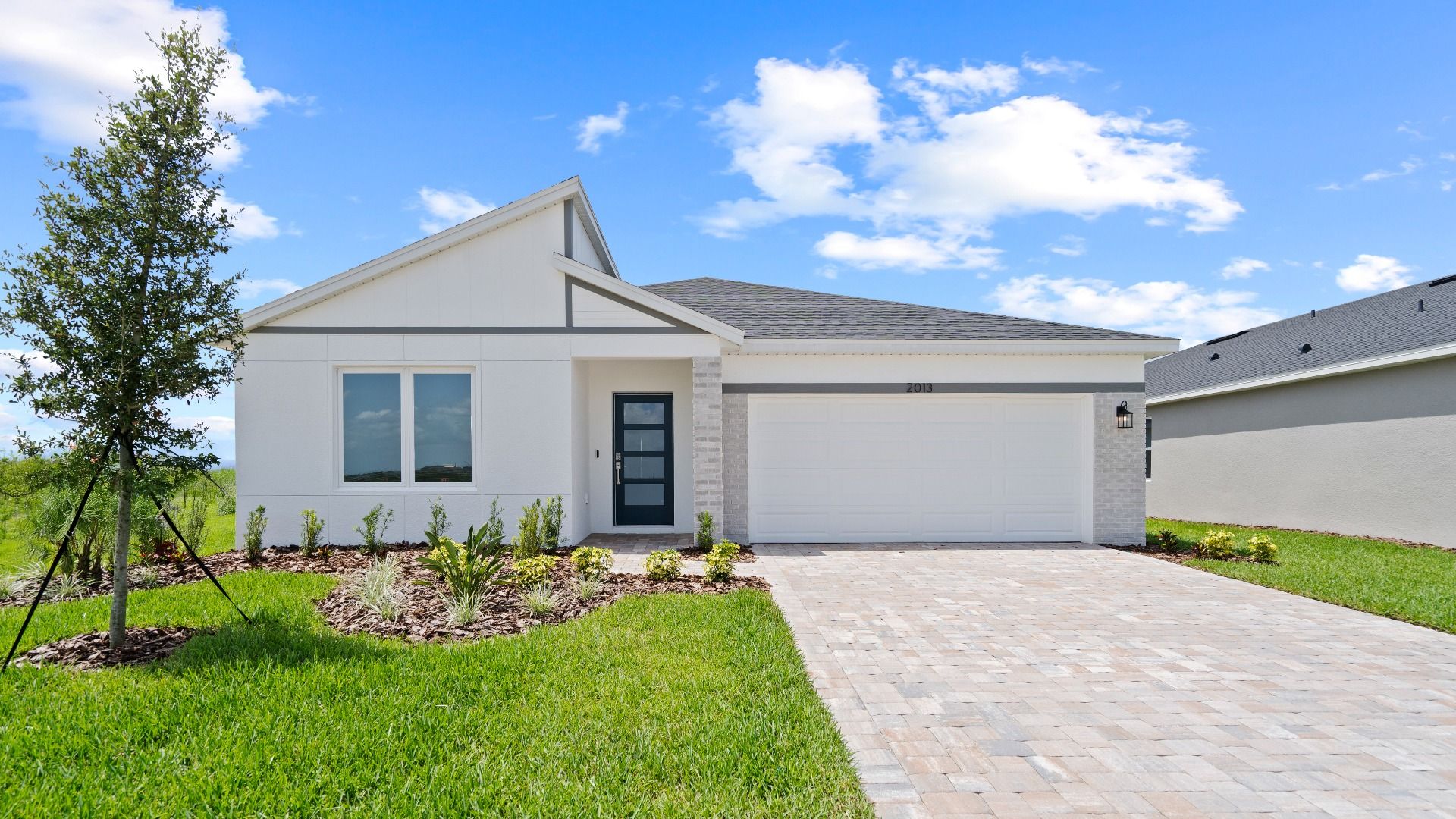 The Atwood at Hamilton Bluff offers single-story living with a spacious layout, paver driveway, and charming curb appeal.
