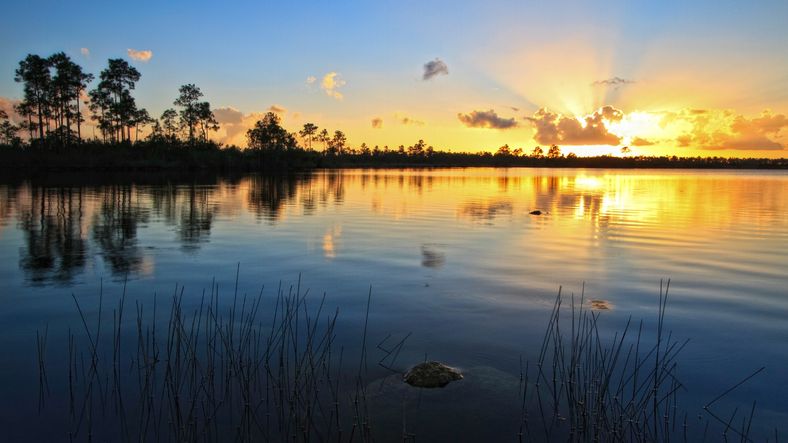 Scenic lake view at sunset with vibrant skies reflecting on the water—capturing the beauty of nature and peaceful evenings.