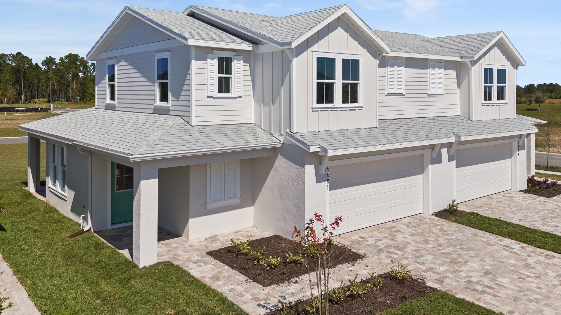 Monterey elevation at Cyrene at Harmony — a spacious two-story design with a two-car garage and coastal exterior charm.