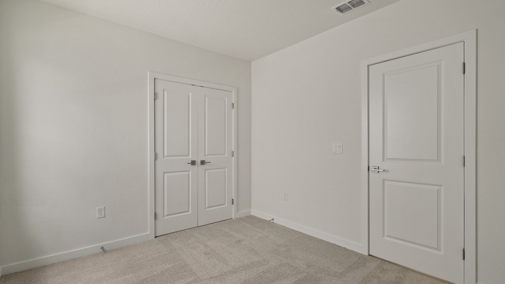 Carpeted flex space with closet and clean finishes—perfect for a home office, gym, playroom, or guest room