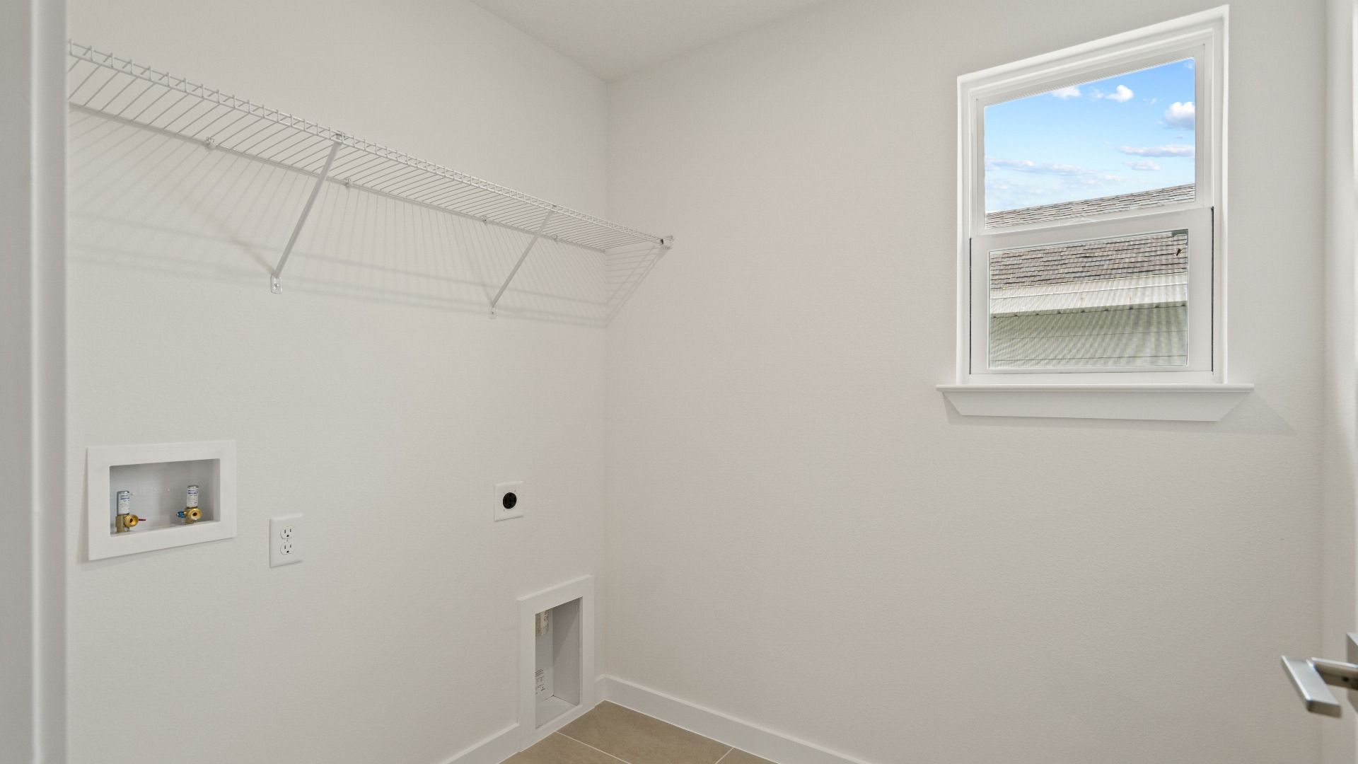 Second bedroom walk-in closet with built-in shelving and window—offering practical storage and a bright, airy feel