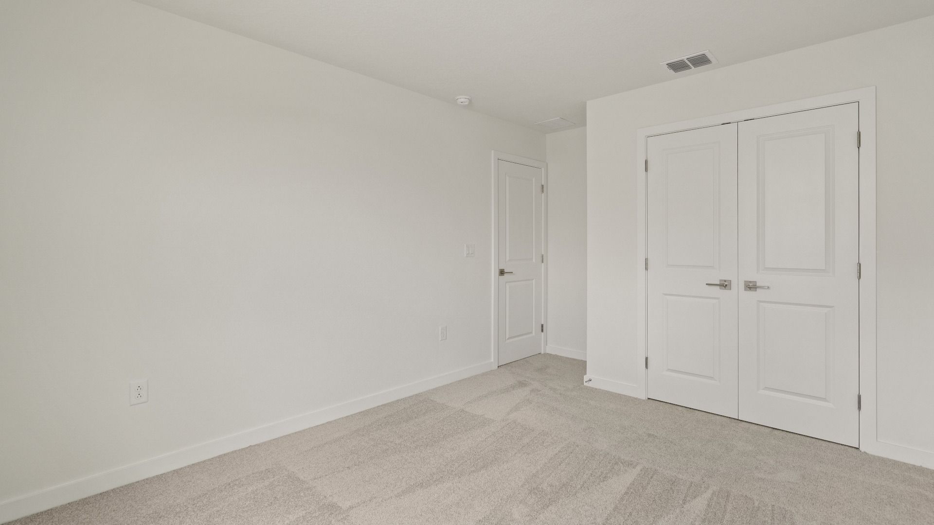 Spacious third bedroom with generous closet space and neutral tones—ideal for guests, kids, or a home office