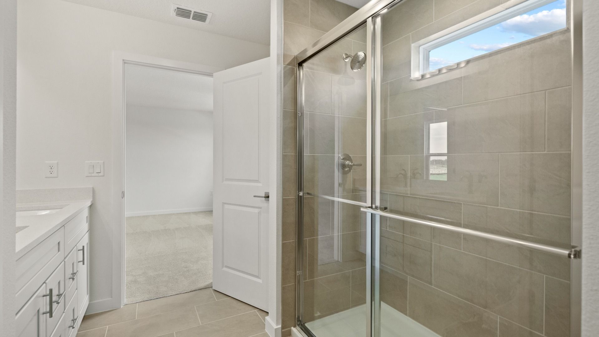Contemporary primary bath featuring a sleek glass shower, dual sinks, and elegant tilework for a spa-like feel