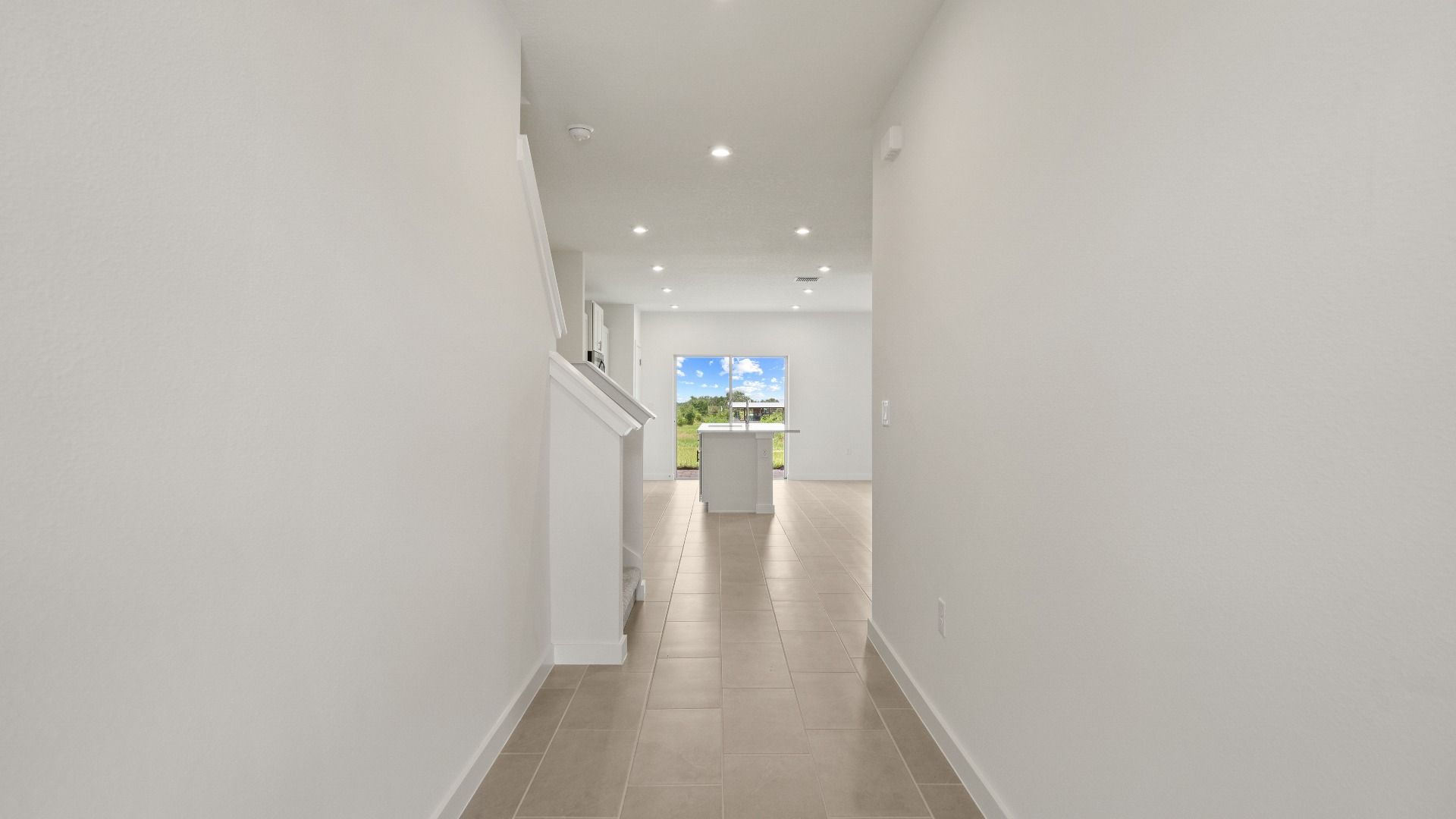Welcoming entryway in the Ponte Vedra home with sleek flooring, recessed lighting, and a clean and modern look.