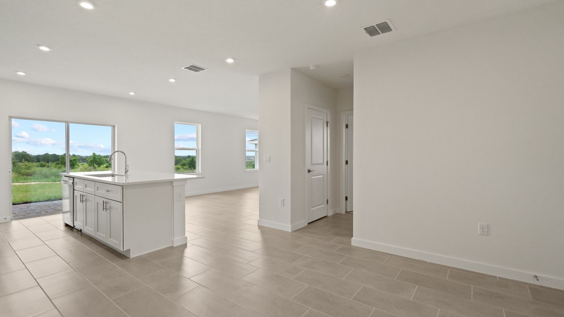 Spacious kitchen opens to bright living area—perfect for entertaining, with modern finishes and plenty of natural light