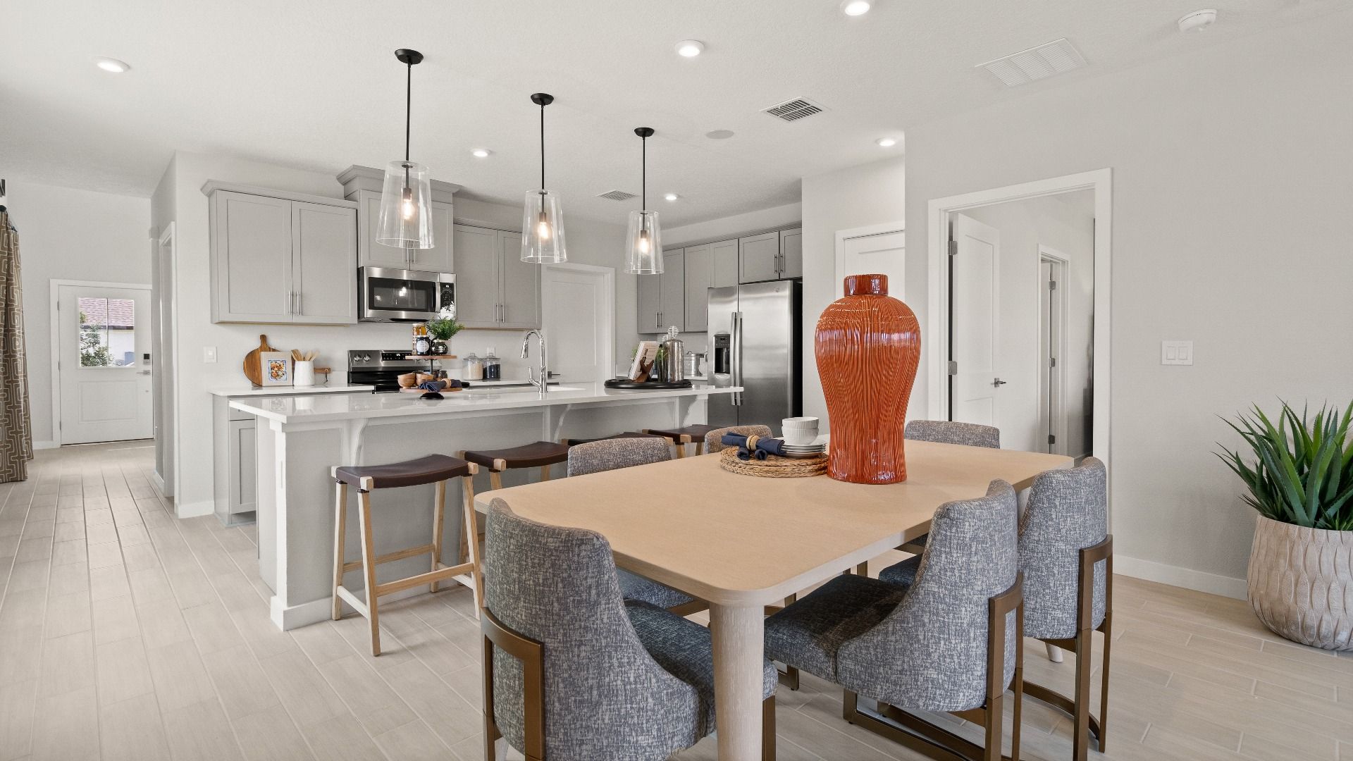 Jupiter Model open concept dining and living room by DRB Homes at Grasslands West, a new community in Lakeland, FL.