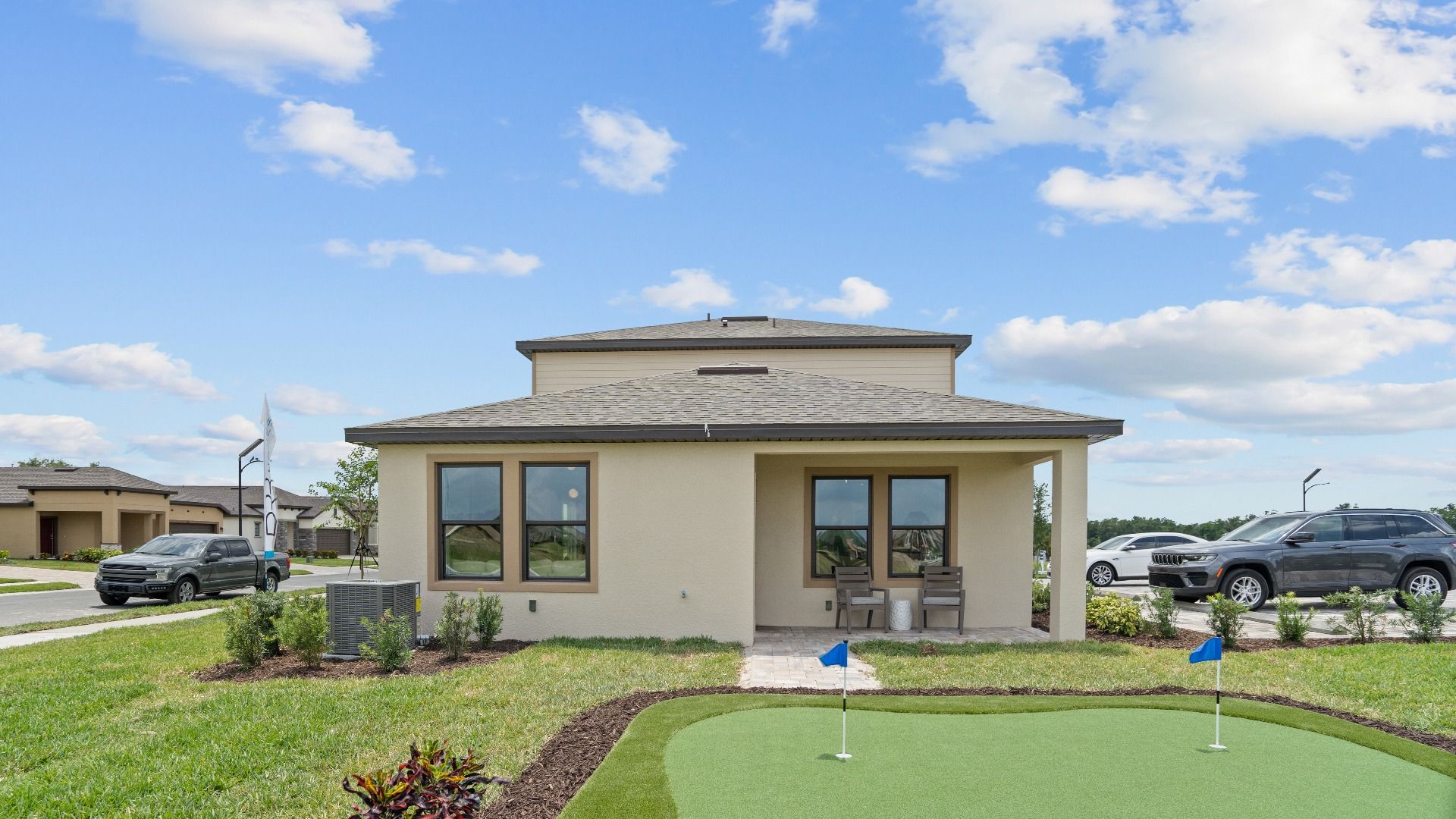 Enjoy a private putting green and covered patio backyard of the Jupiter Model at Grasslands West by DRB Homes in Lakeland, FL