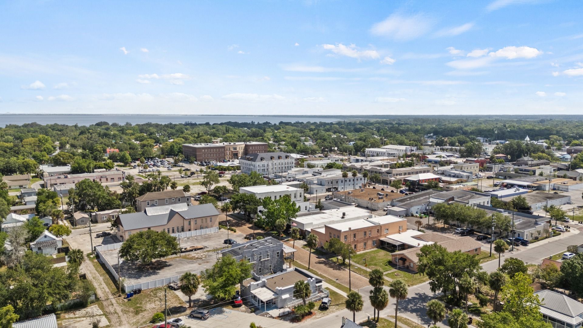 Aerial view of downtown St. Cloud FL showcasing historic buildings, Lake Tohopekaliga in the distance near Cyrene at Harmony.