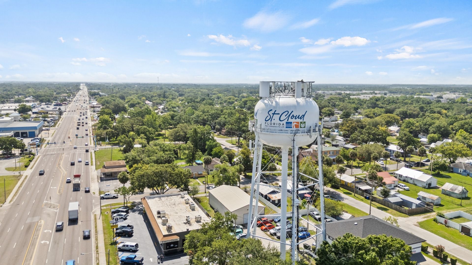 St. Cloud, FL water tower with a panoramic view of city streets, homes, and businesses near Cyrene at Harmony.