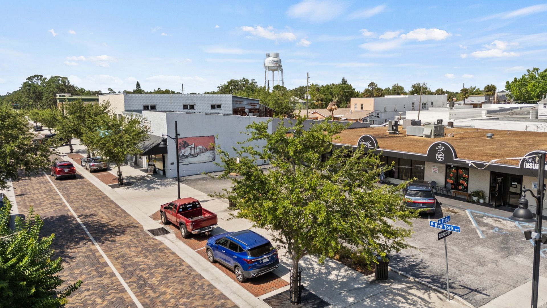 Brick-paved streets with the St. Cloud water tower and local shops in historic downtown St. Cloud, FL near Cyrene at Harmony.