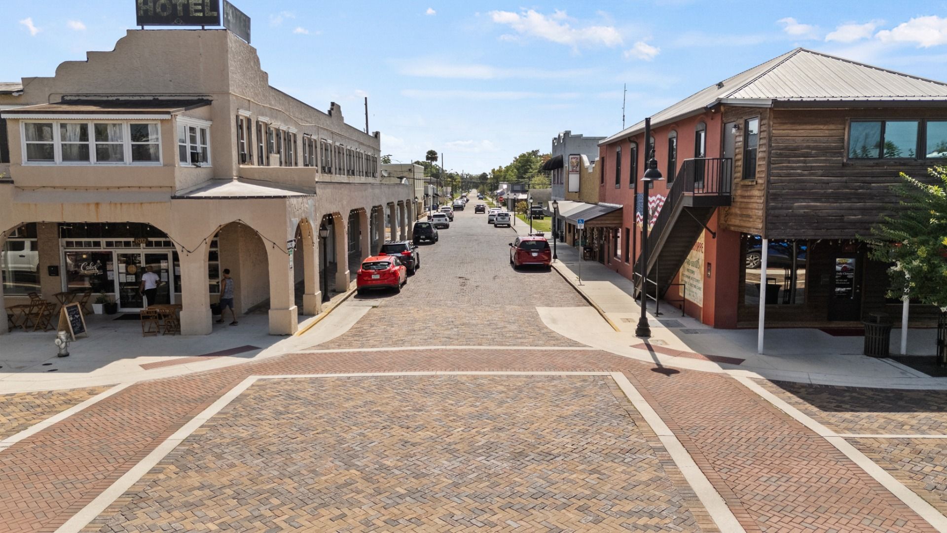 Brick-paved street with historic buildings in downtown St. Cloud, FL, offering charm and character near Cyrene at Harmony.
