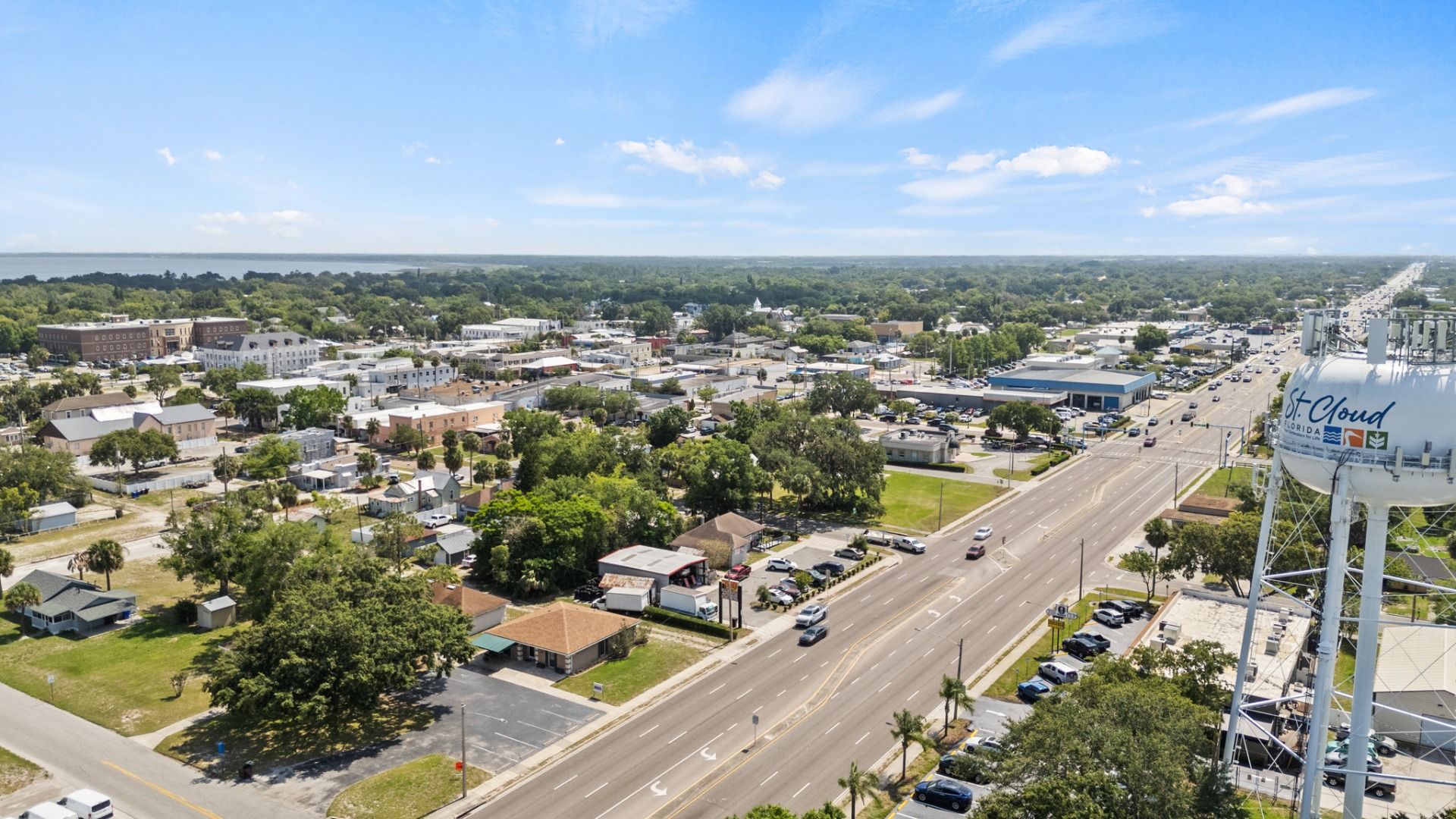 Aerial view of downtown St. Cloud, FL featuring the water tower, local streets, and businesses near Cyrene at Harmony.