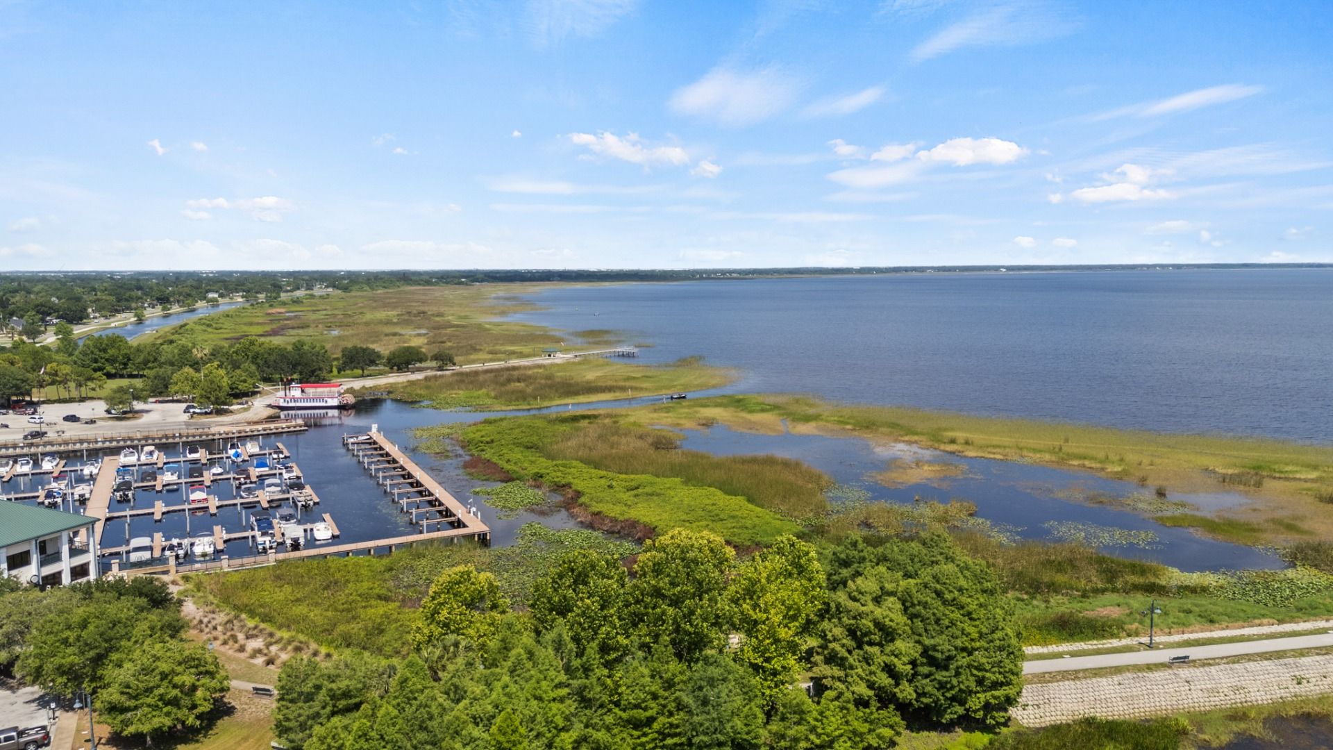 Aerial view of St. Cloud Marina with boat docks and scenic Lake Tohopekaliga shoreline near Cyrene at Harmony.