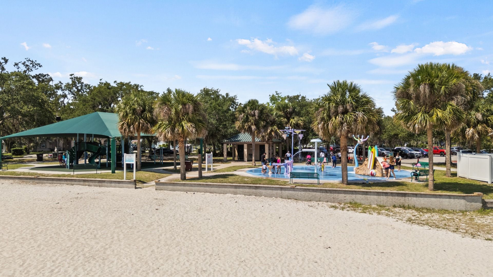 Beach area and splash pad at Lakefront Park in St. Cloud, FL — family fun under the palm trees near Cyrene at Harmony.