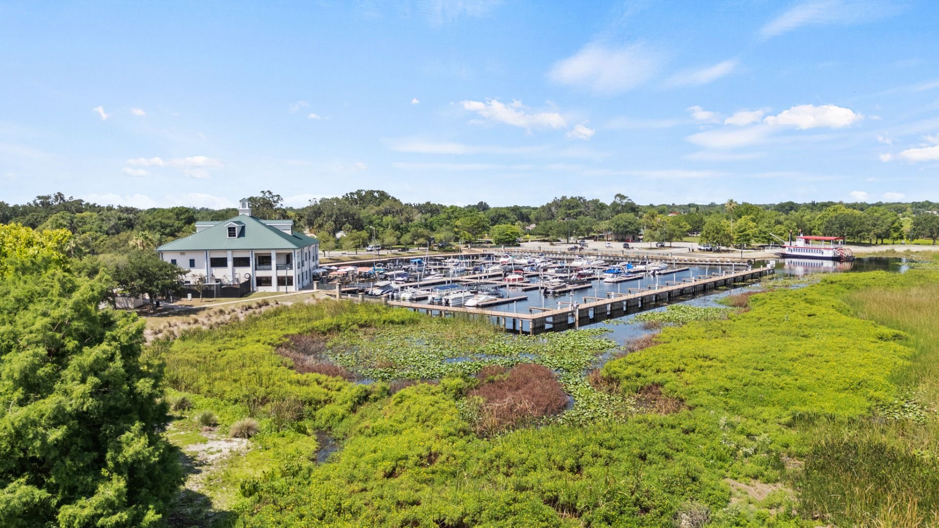Aerial view of St. Cloud Marina with boat docks and scenic Lake Tohopekaliga shoreline near Cyrene at Harmony.