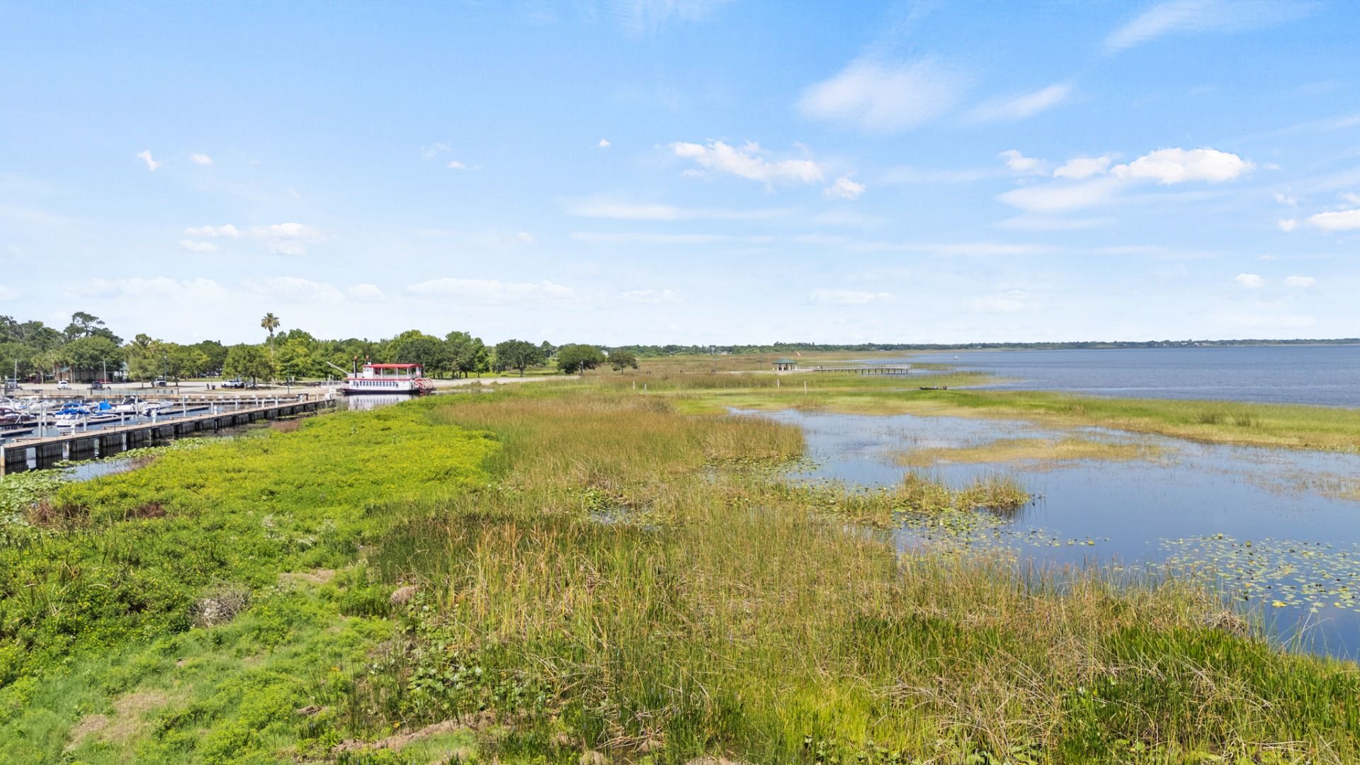 Aerial view of St. Cloud Marina with boat docks and scenic Lake Tohopekaliga shoreline near Cyrene at Harmony.