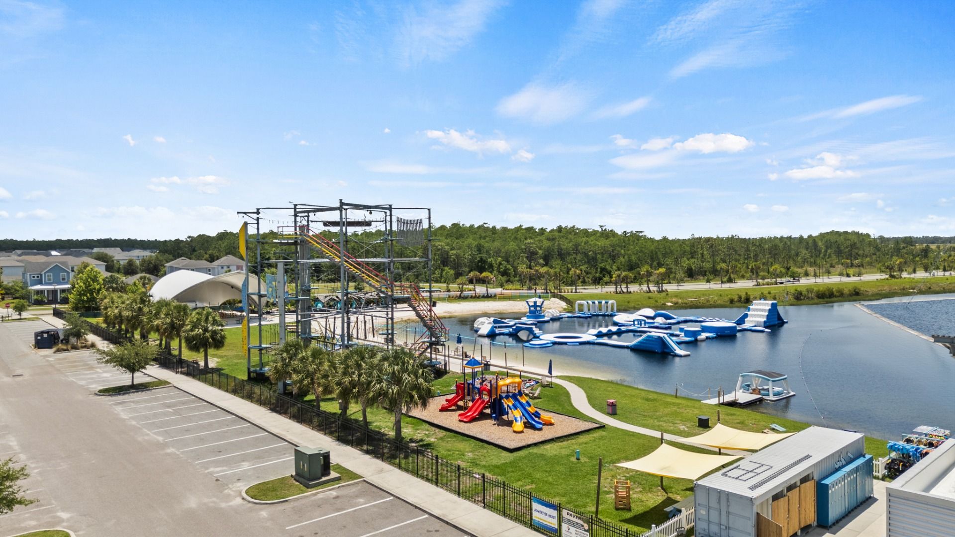 Nona Adventure Park in Lake Nona, FL featuring a water obstacle course, ropes course, and playground for all ages.