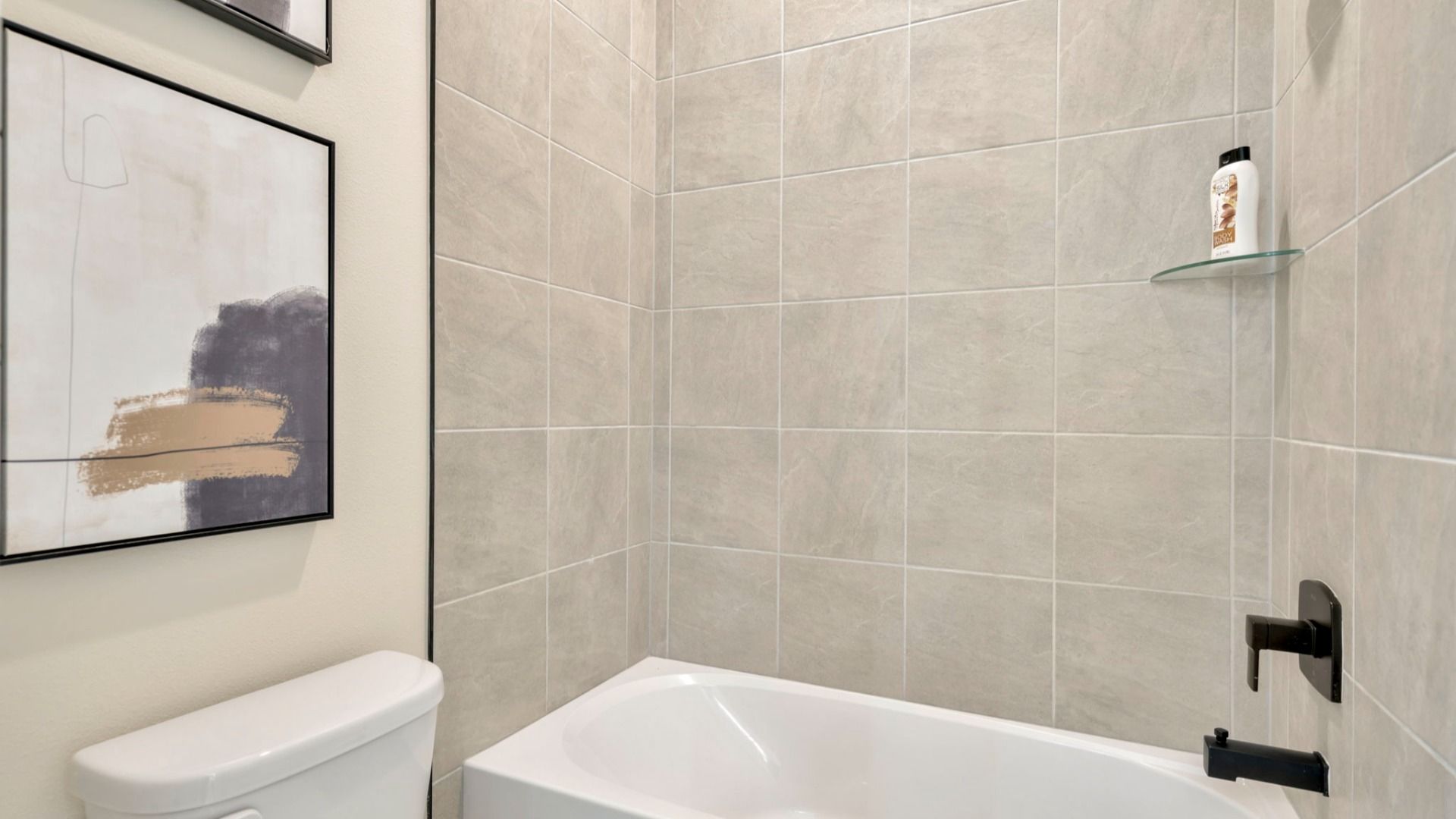 The Jack and Jill Bathroom of a DRB Homes Grand Eider model, which is a home plan offered at Serengeti in Spring Hill, FL.