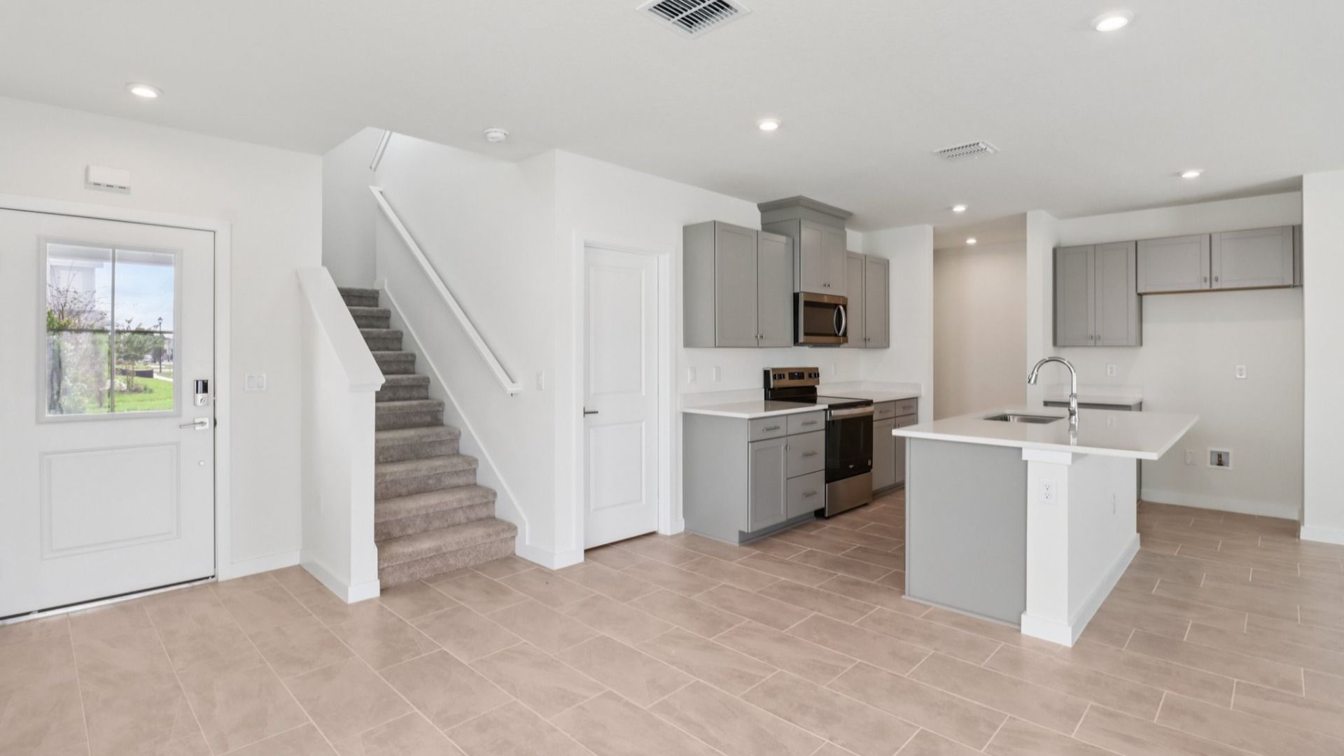 Kitchen and Entry in the Monterey End Townhome by DRB Homes - Cyrene at Harmony in St Cloud FL