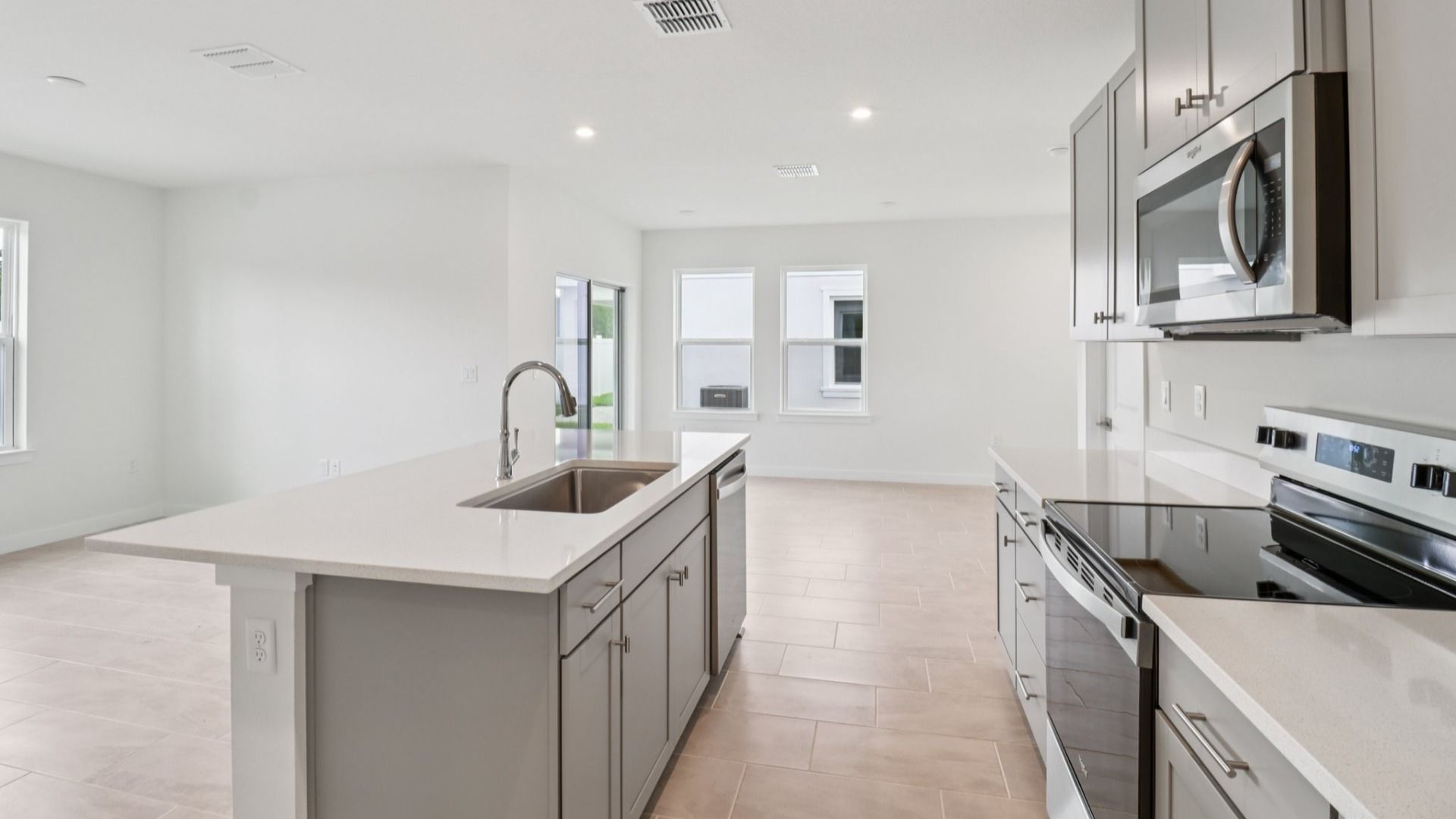 Kitchen and Living Room in the Monterey End Townhome by DRB Homes - Cyrene at Harmony in St Cloud FL