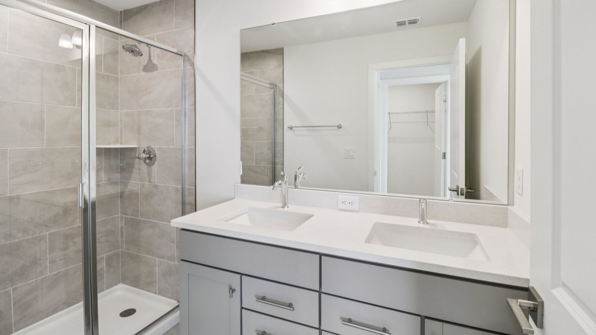 Primary Bath with dual sinks in the Monterey - End Townhome by DRB Homes at Cyrene at Harmony in St Cloud FL