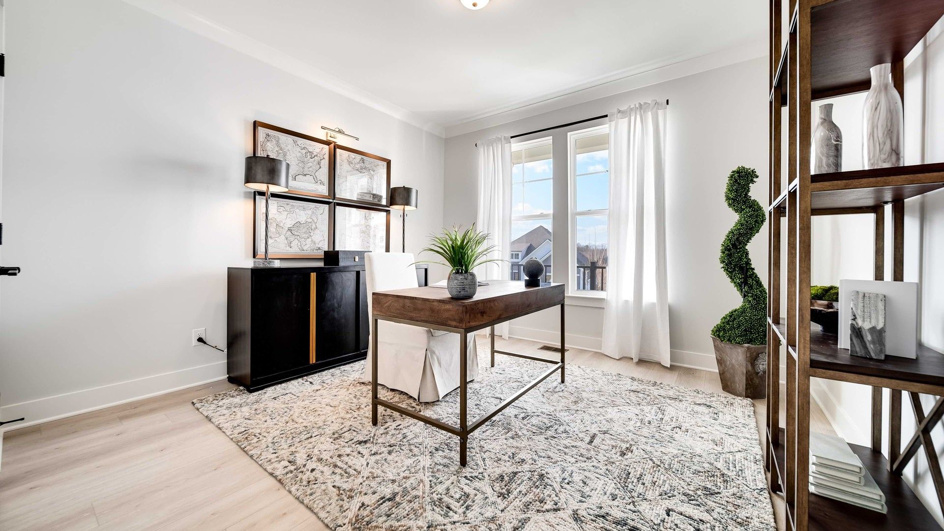 Modern home office in Richvale Estates features minimalist design, rich wood accents, and abundant natural light.