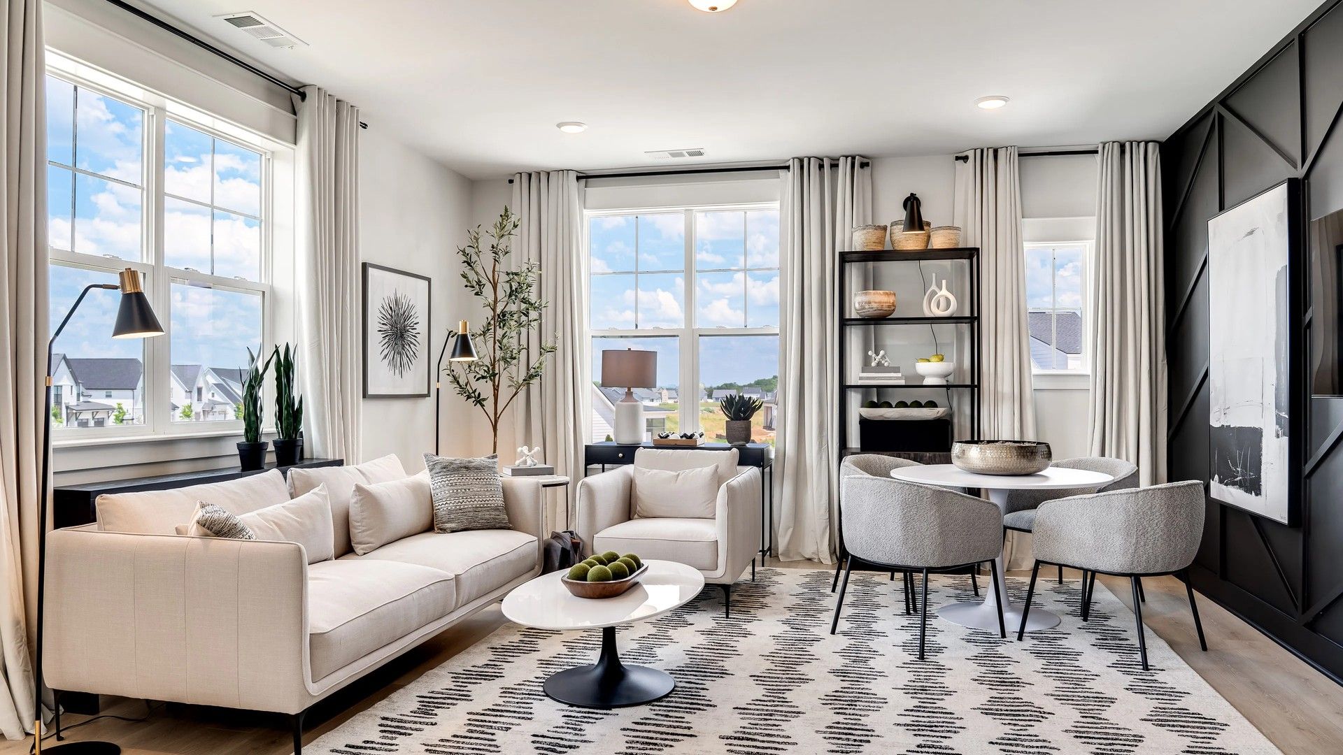 Experience refined design with spacious windows, abstract art, and a chic patterned rug in Tennessee's Shelton Square.